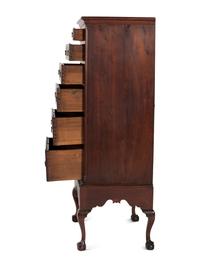 A Chippendale Carved and Figured Walnut Chest on Claw-and-Ball Foot Stand
