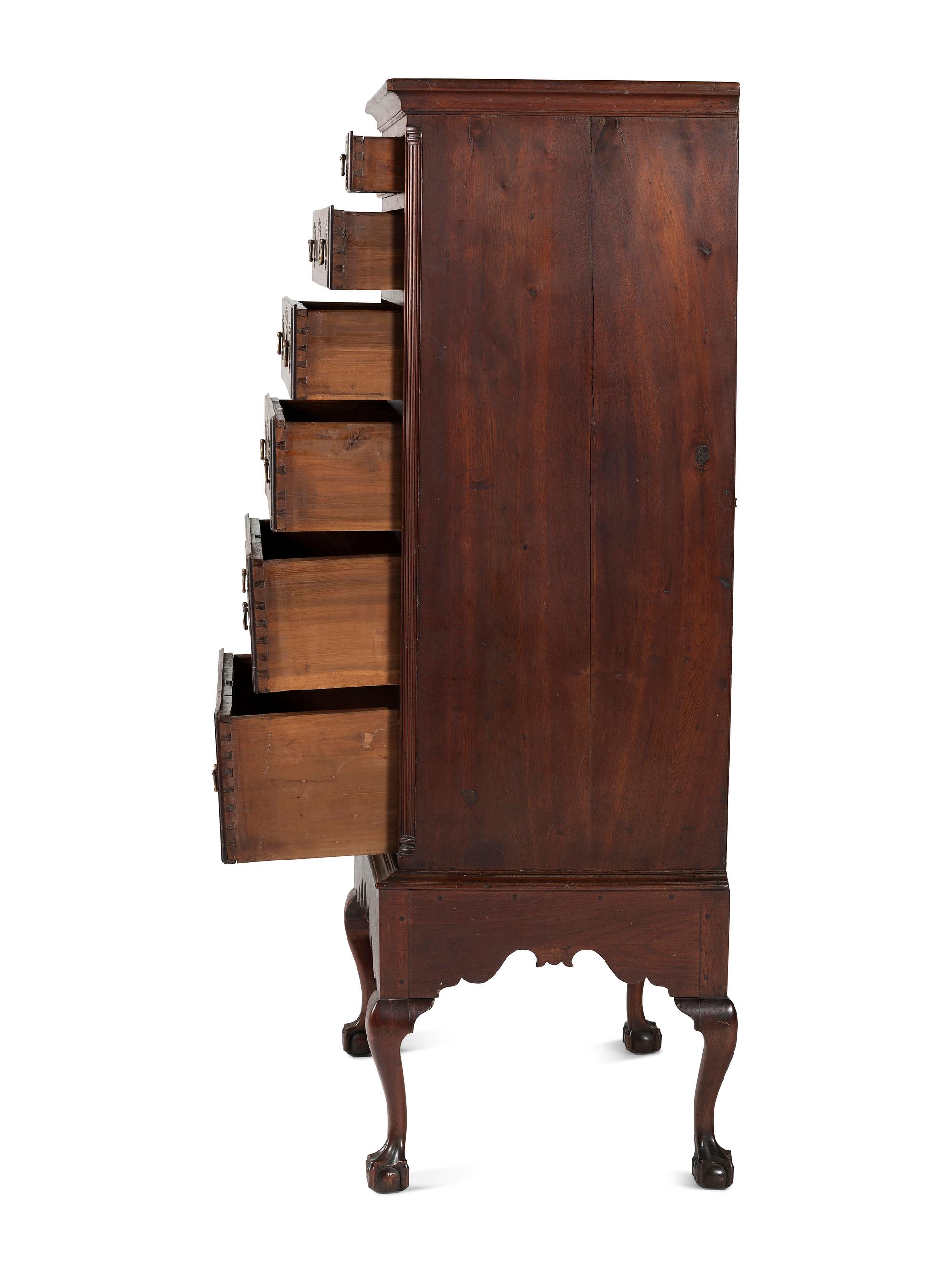 A Chippendale Carved and Figured Walnut Chest on Claw-and-Ball Foot Stand