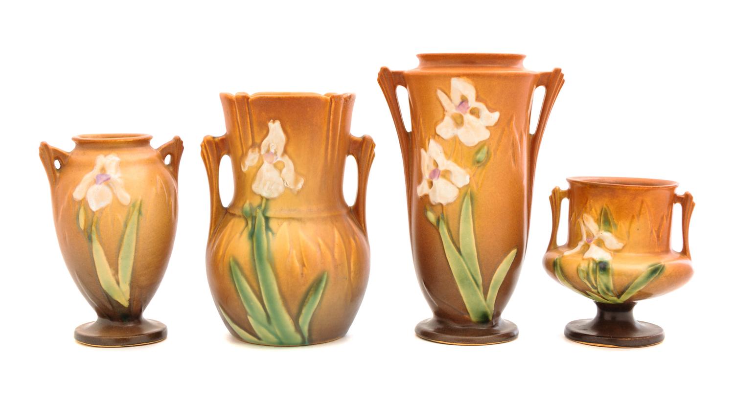 Four Roseville Iris Pottery Vases Heights: 7 1/4, 6 1/4, 5 1/4 and 4 inches.