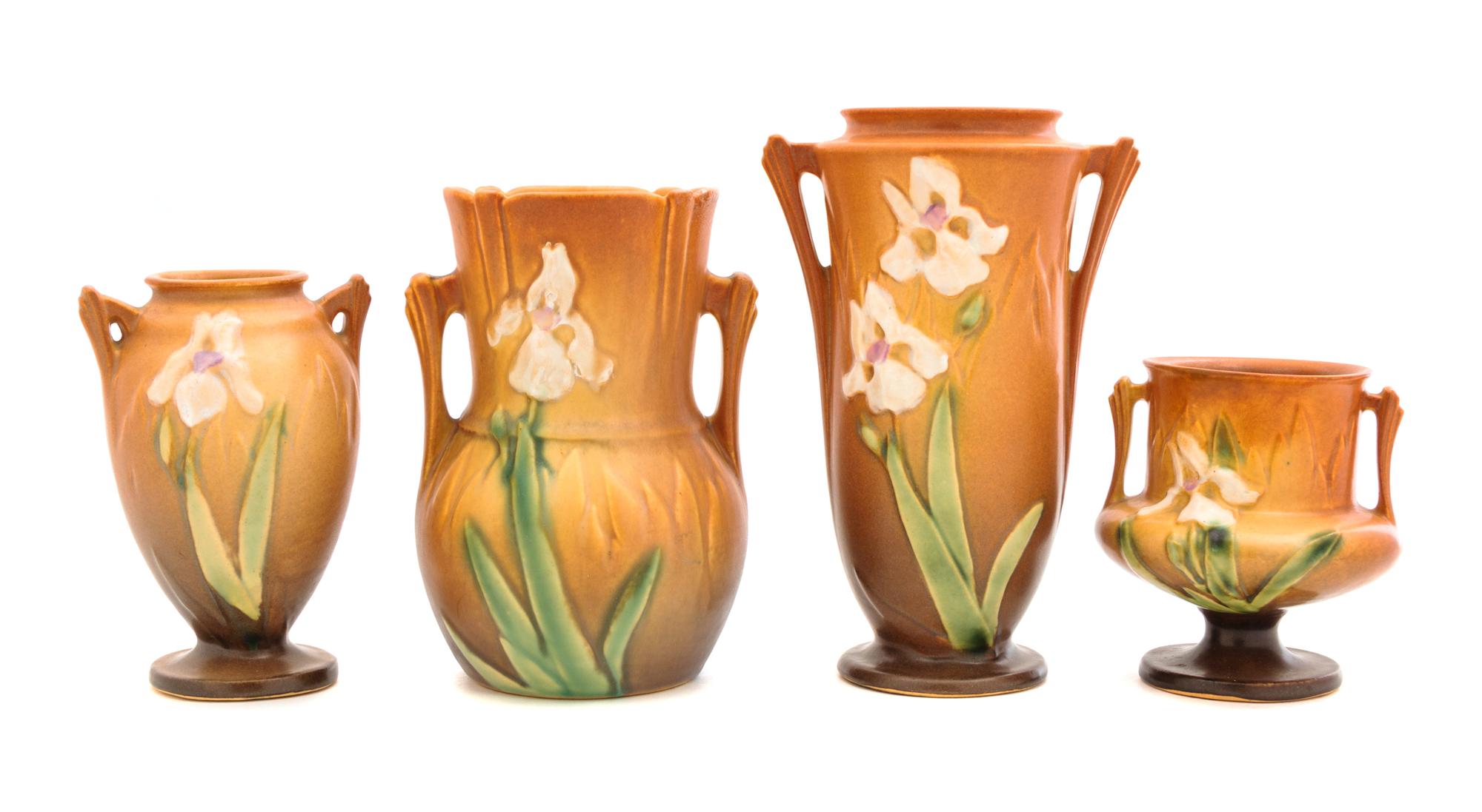 Four Roseville Iris Pottery Vases Heights: 7 1/4, 6 1/4, 5 1/4 and 4 inches.
