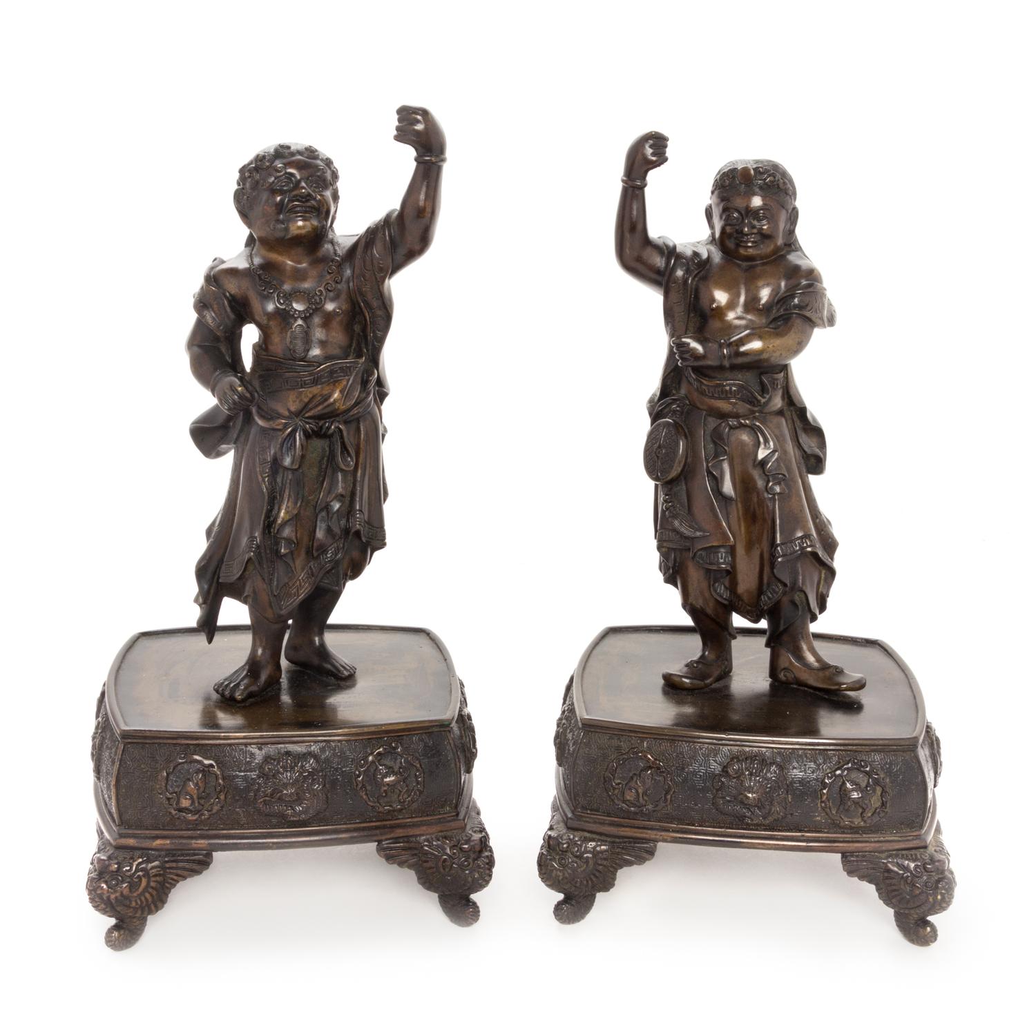 A Pair of Japanese Bronze Guardian-Form Candle Holders Height of each 12 3/4 inches. — MEIJI PERIOD (1868-1912)