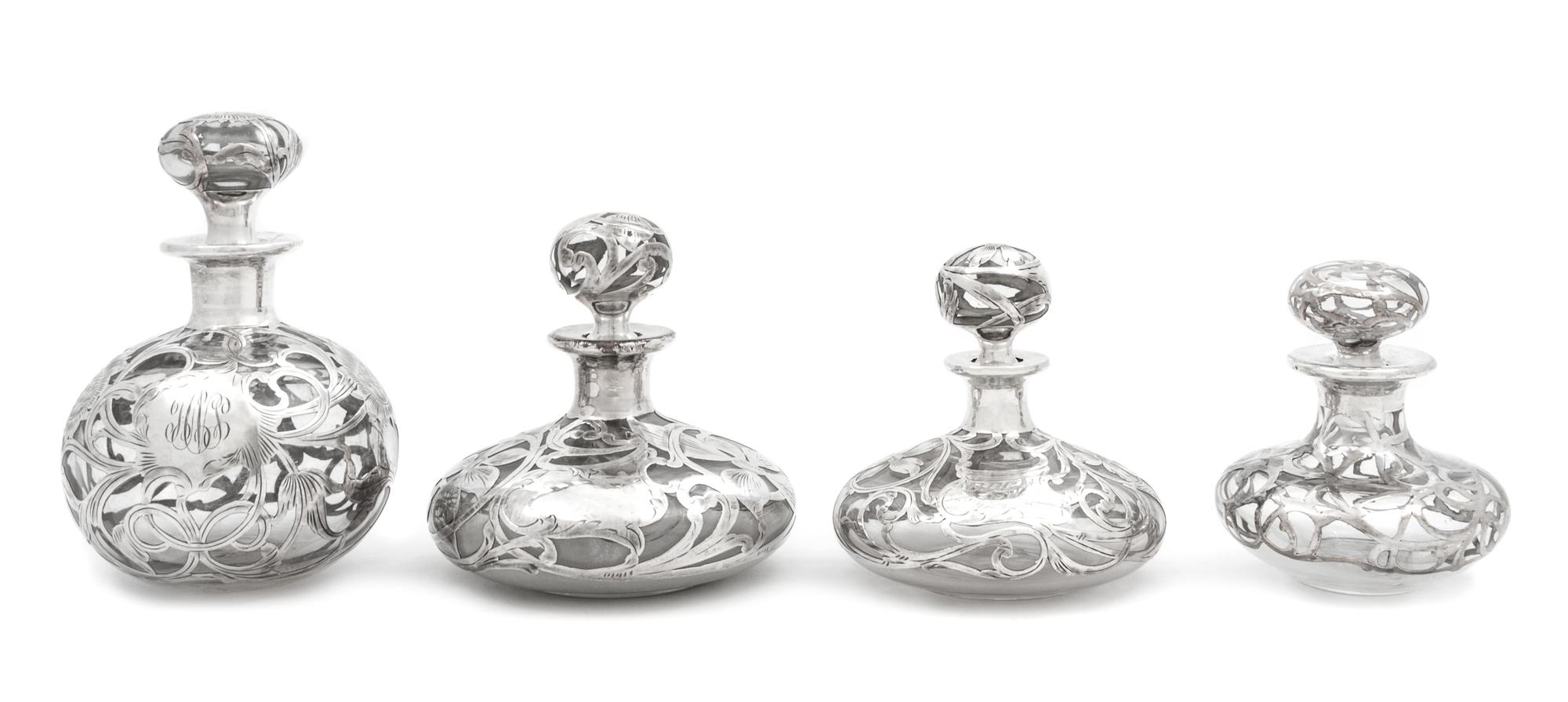 A Group of Four Silver Overlay Glass Scent Bottles Height of tallest 5 3/4 inches.