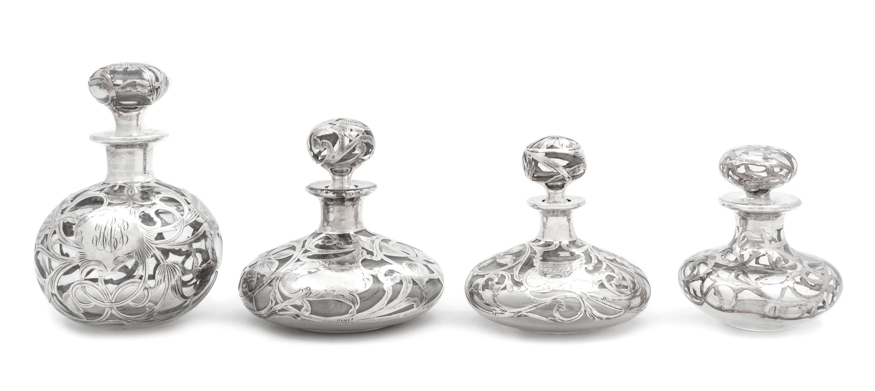 A Group of Four Silver Overlay Glass Scent Bottles Height of tallest 5 3/4 inches.
