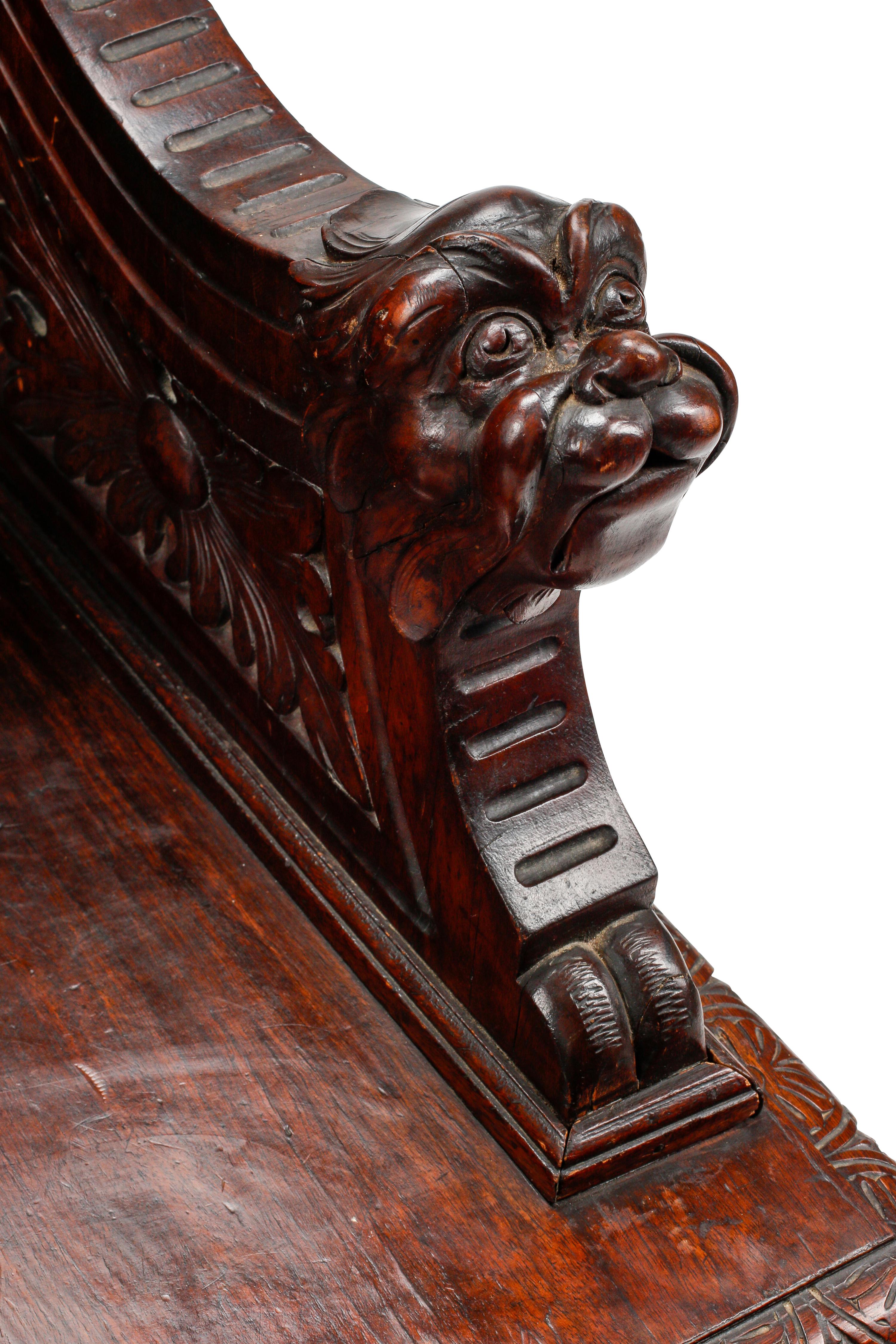 An Italian Renaissance Revival Carved Walnut Settle