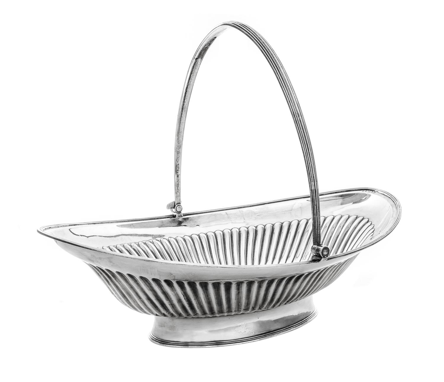 A George III Silver Basket, Joseph Scammell, London, 1795, oval form with reeded sides and swing handle, center engraved with arms.