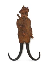 A Black Forest Carved Musical Coat Hook, Height 14 inches.