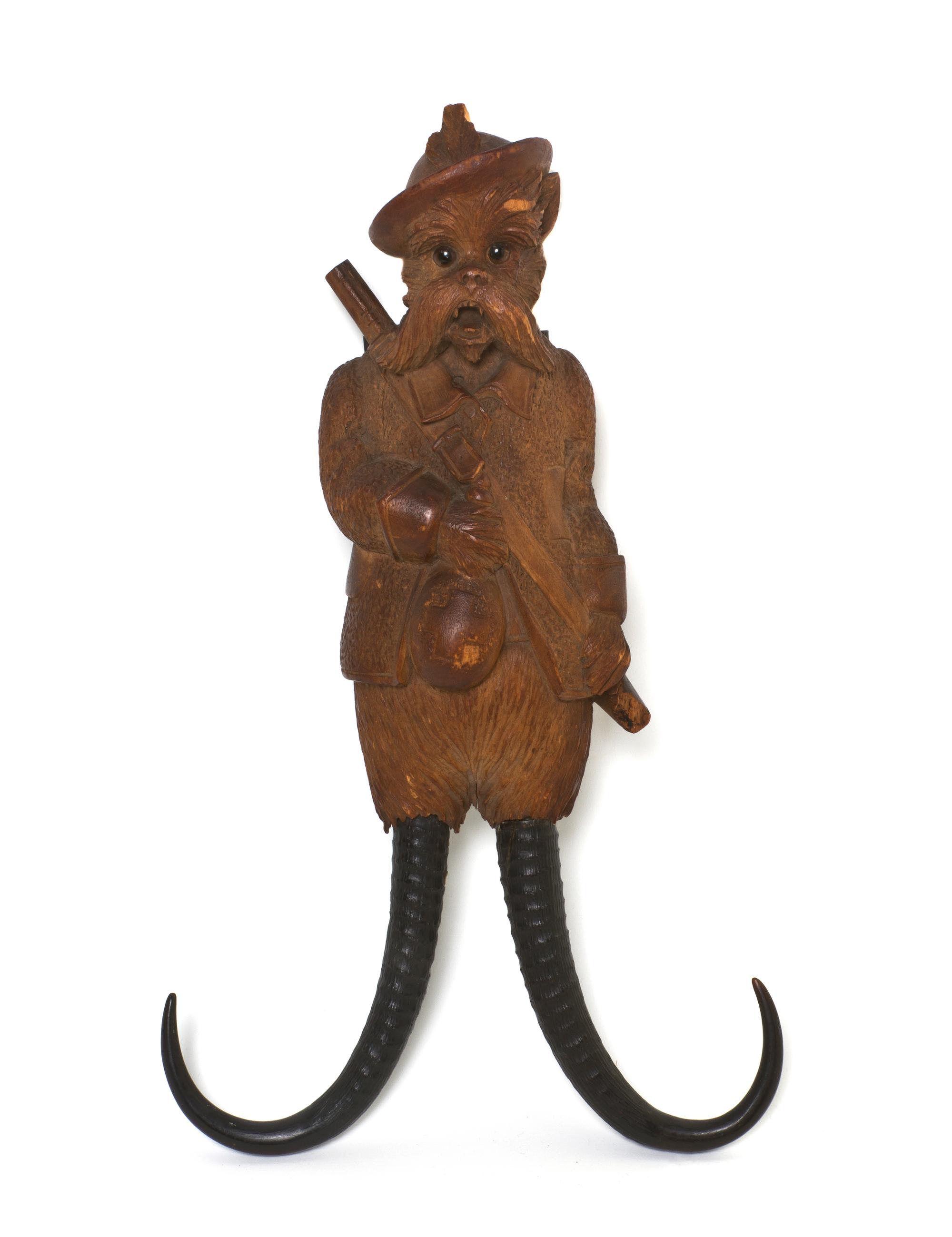 A Black Forest Carved Musical Coat Hook, Height 14 inches.