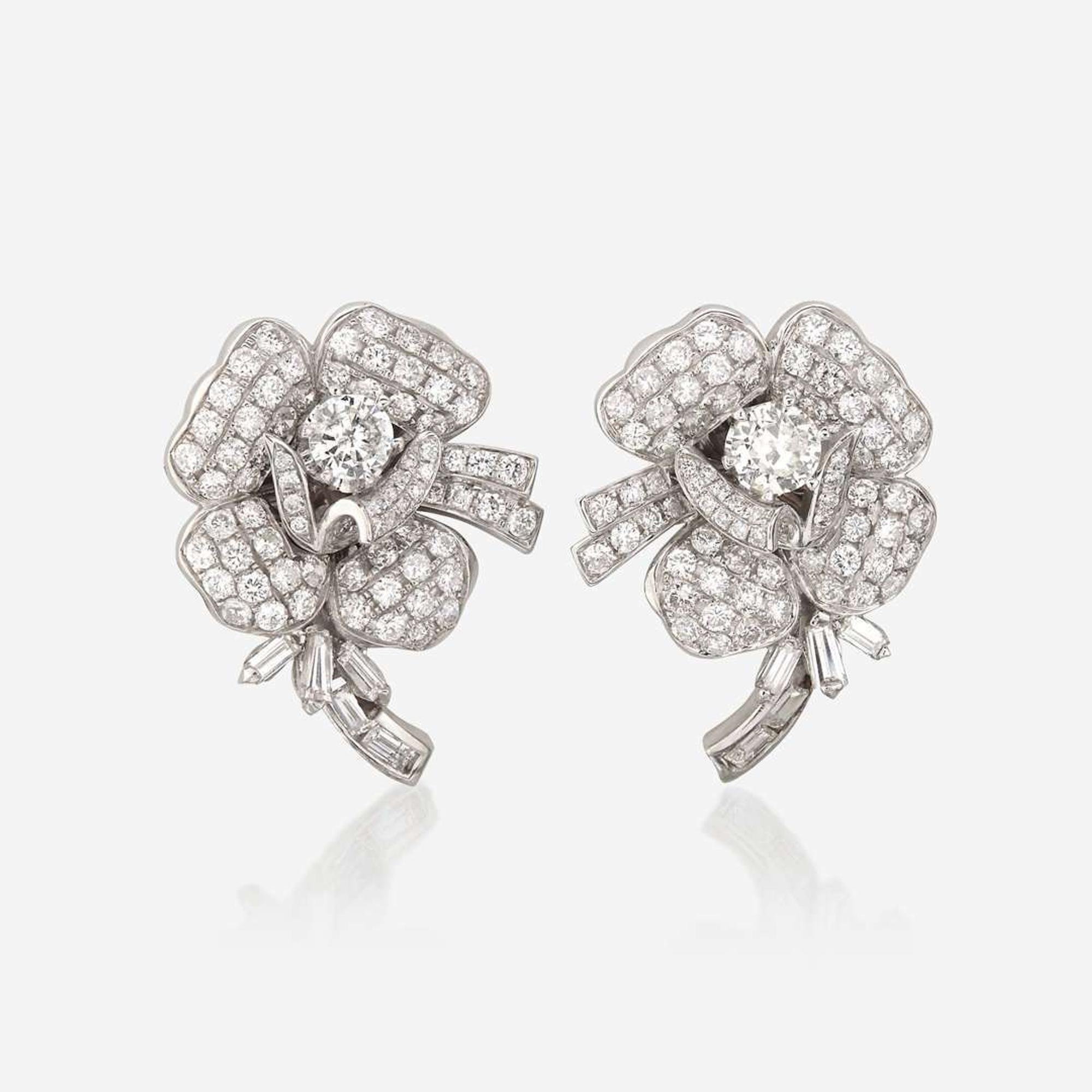 A pair of diamond and eighteen karat white gold earrings
