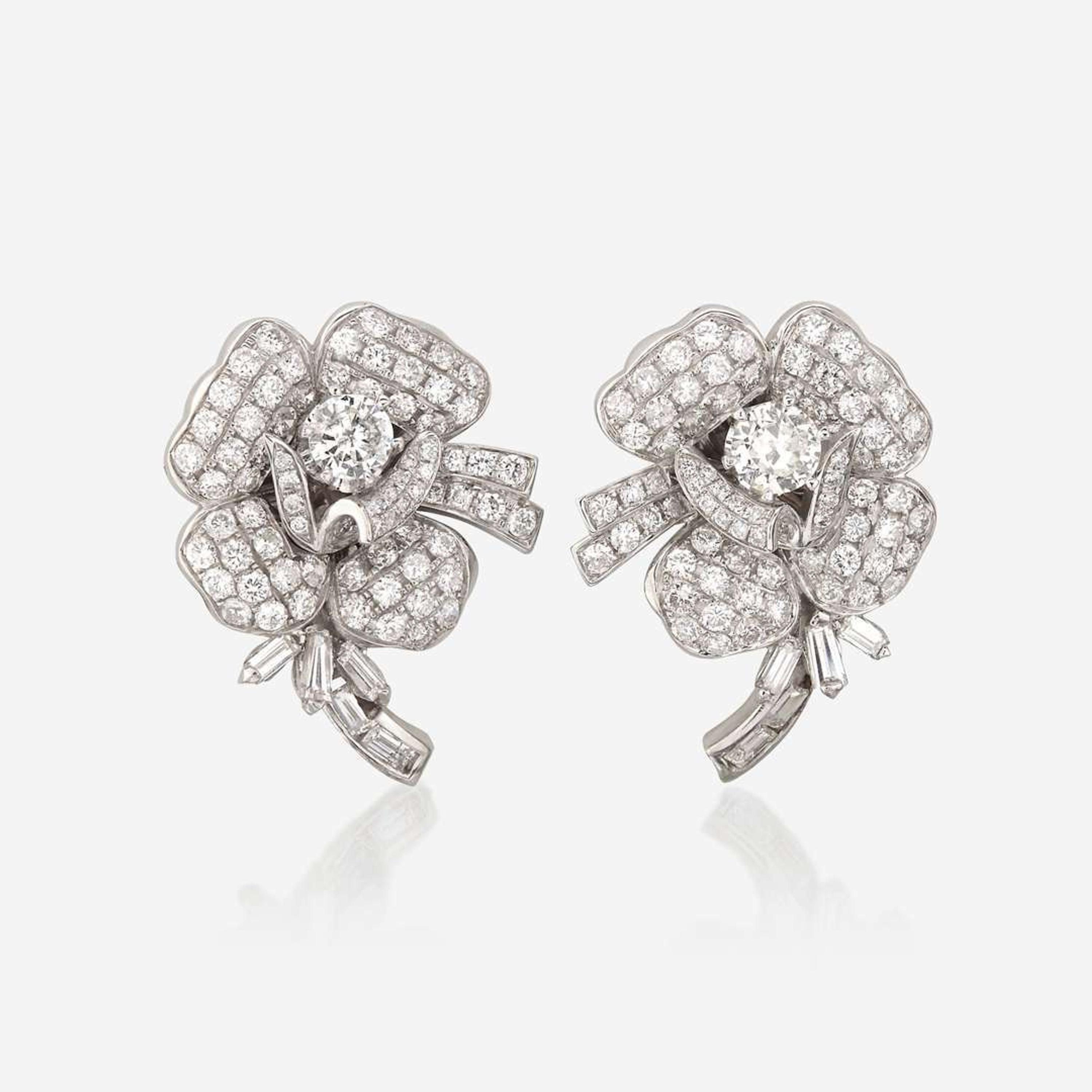 A pair of diamond and eighteen karat white gold earrings