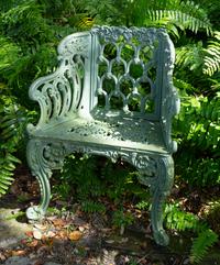 A Green-Painted Metal Garden Bench and Pair of Armchairs