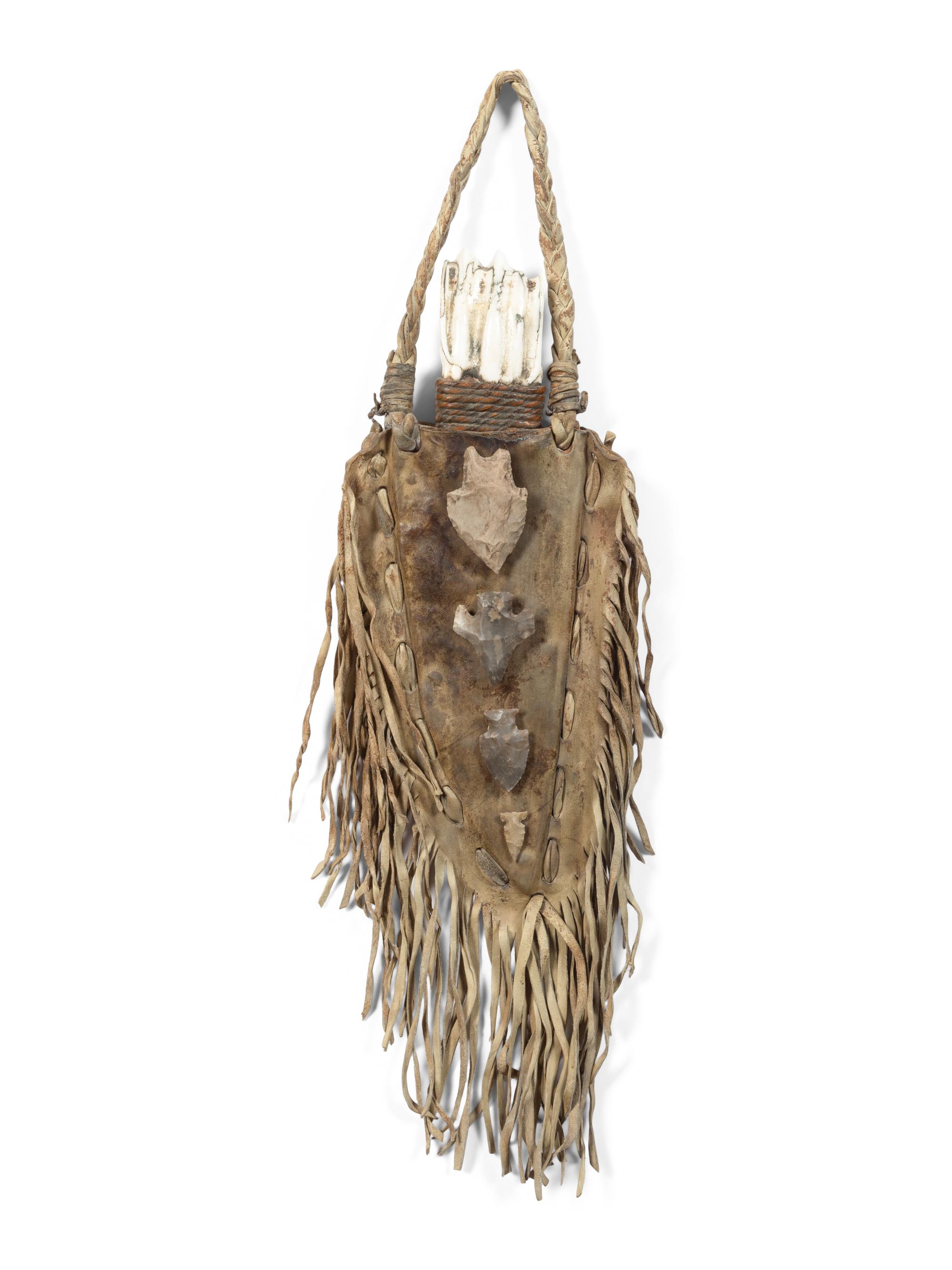 A Fringed Leather or Hide Bag with Attached Arrowheads
