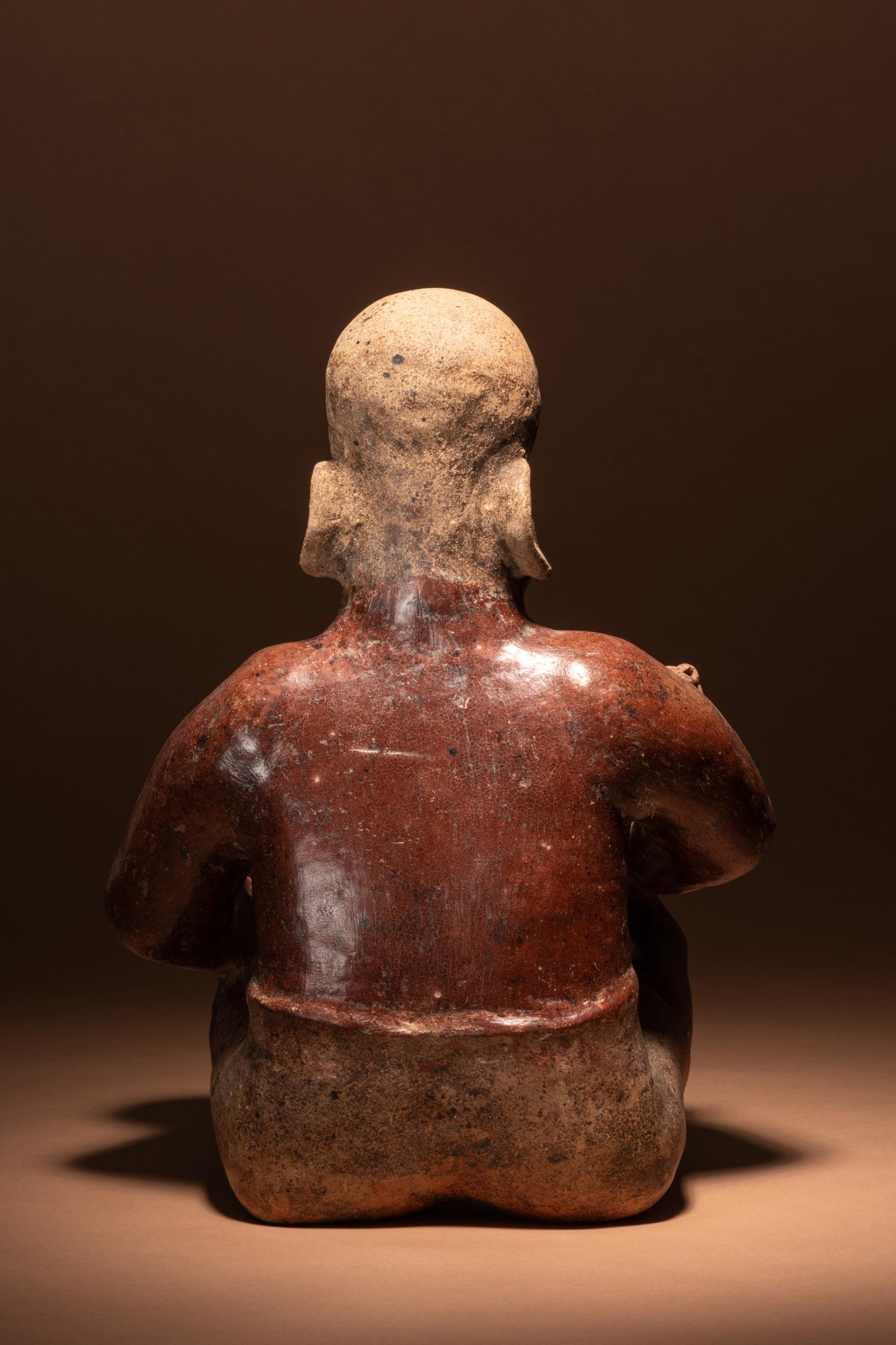 A Jalisco Seated Figure with Offerings