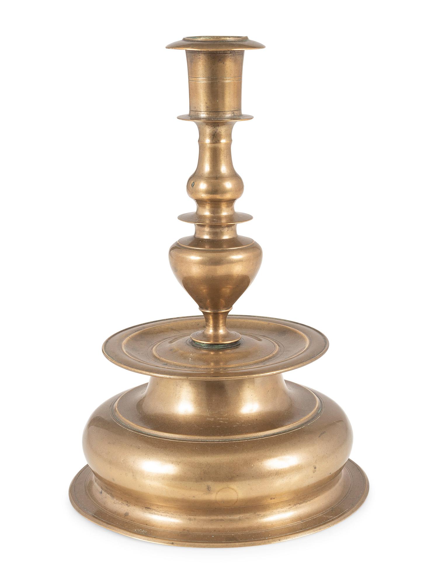 A Rare Continental Brass Bell-Bottom Candlestick