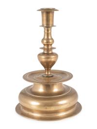 A Rare Continental Brass Bell-Bottom Candlestick