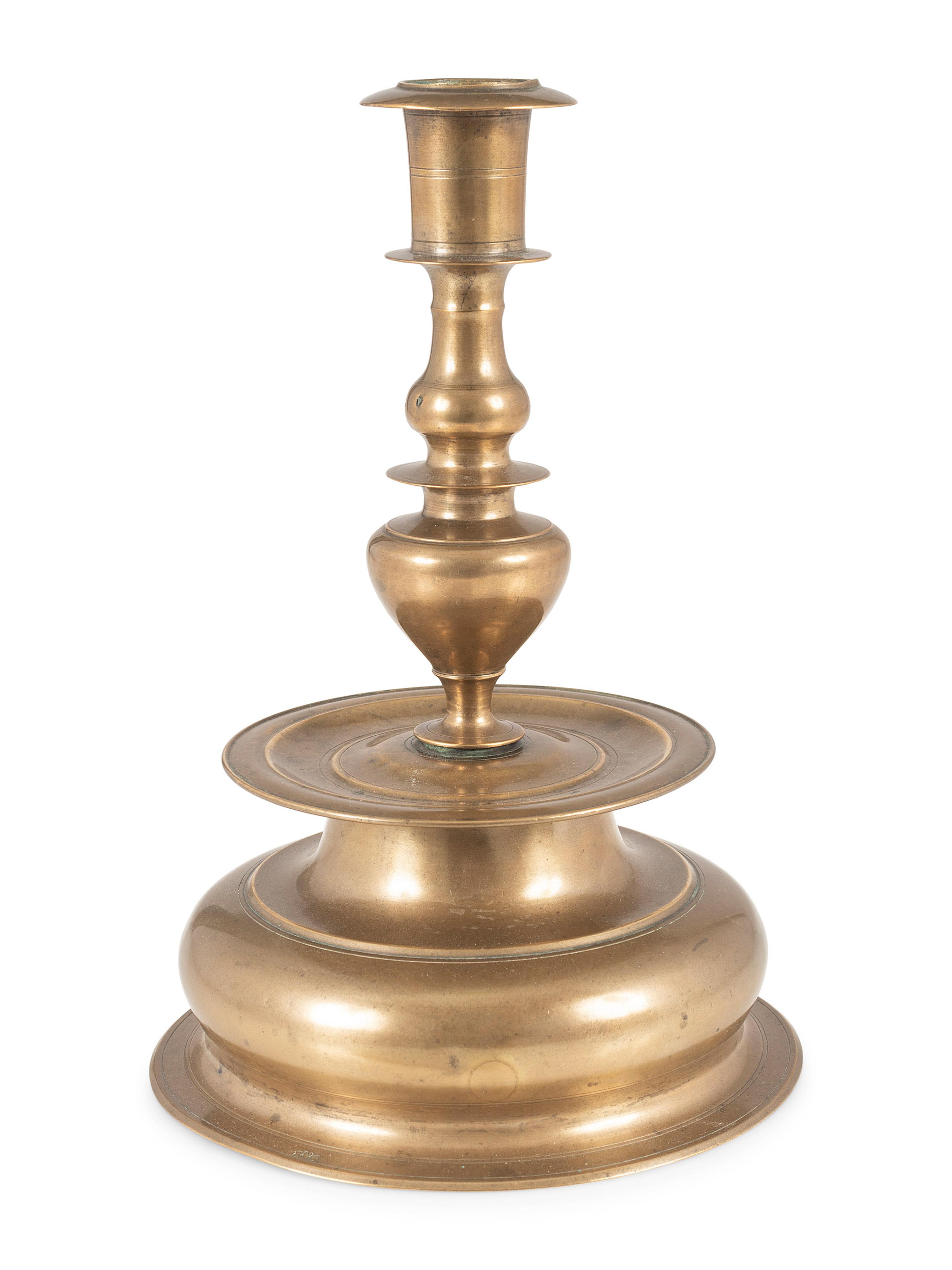A Rare Continental Brass Bell-Bottom Candlestick