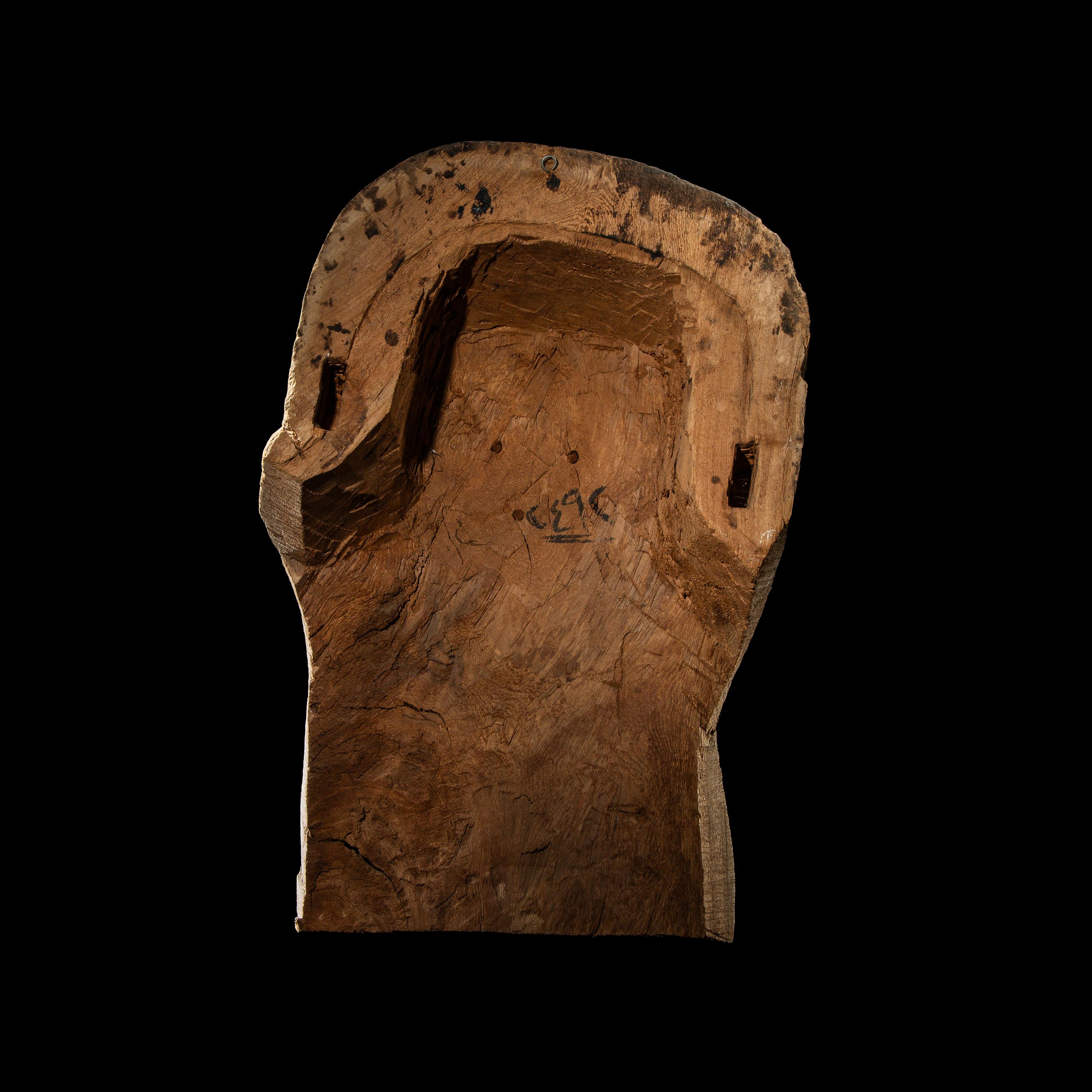 An Egyptian Painted Wood Sarcophagus Head