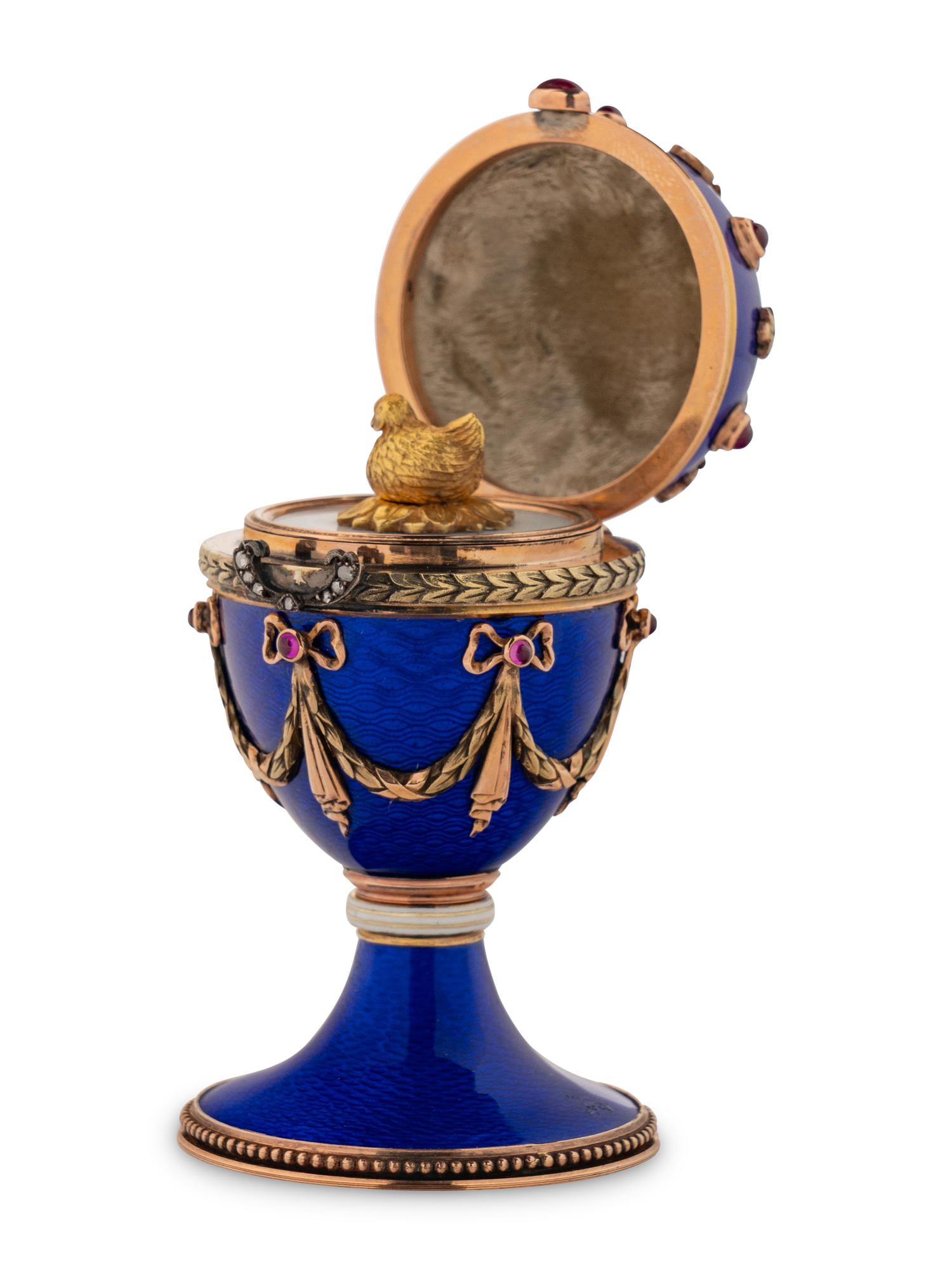 A 14 Karat Vari-Color Gold, Guilloché Enamel, Diamond, and Cabochon Jewel-Mounted Egg-Form Perfume and a Related Guilloché Enamel, 14 Karat Vari-Color Gold, Diamond, and Cabochon-Mounted Surprise Egg