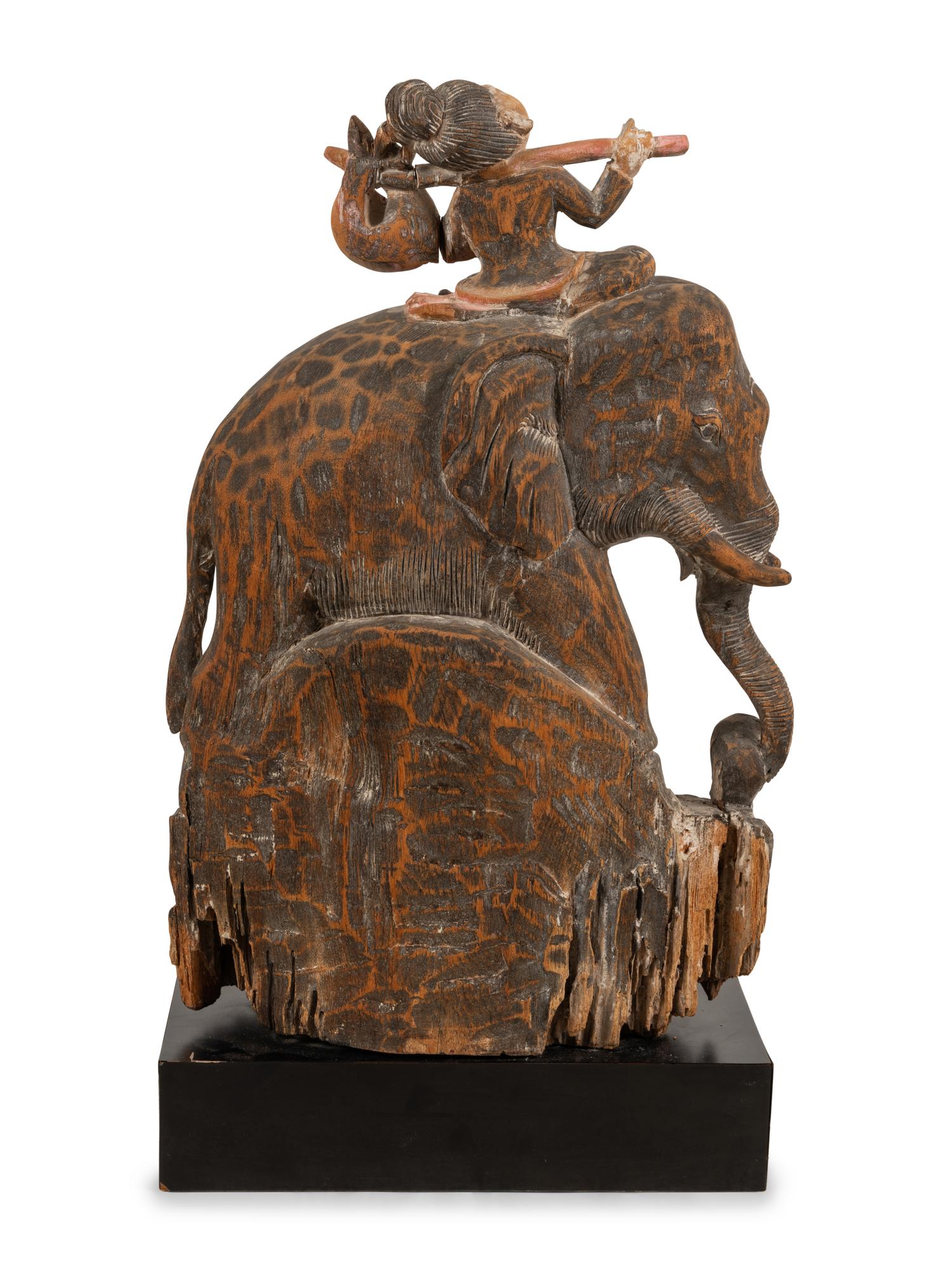 A Southeast Asian Carved and Painted Wood Group of an Elephant and Rider
