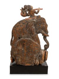 A Southeast Asian Carved and Painted Wood Group of an Elephant and Rider