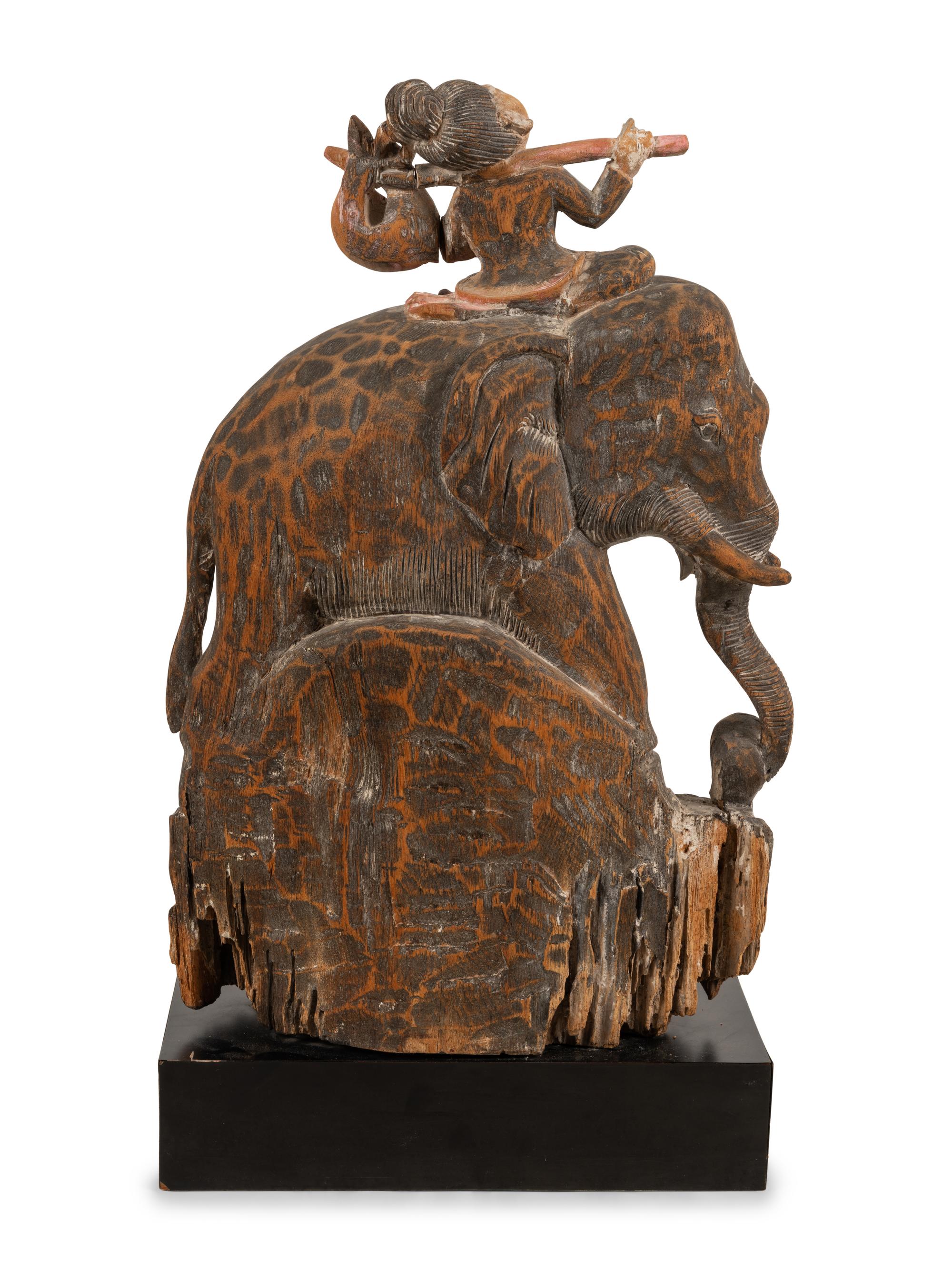 A Southeast Asian Carved and Painted Wood Group of an Elephant and Rider