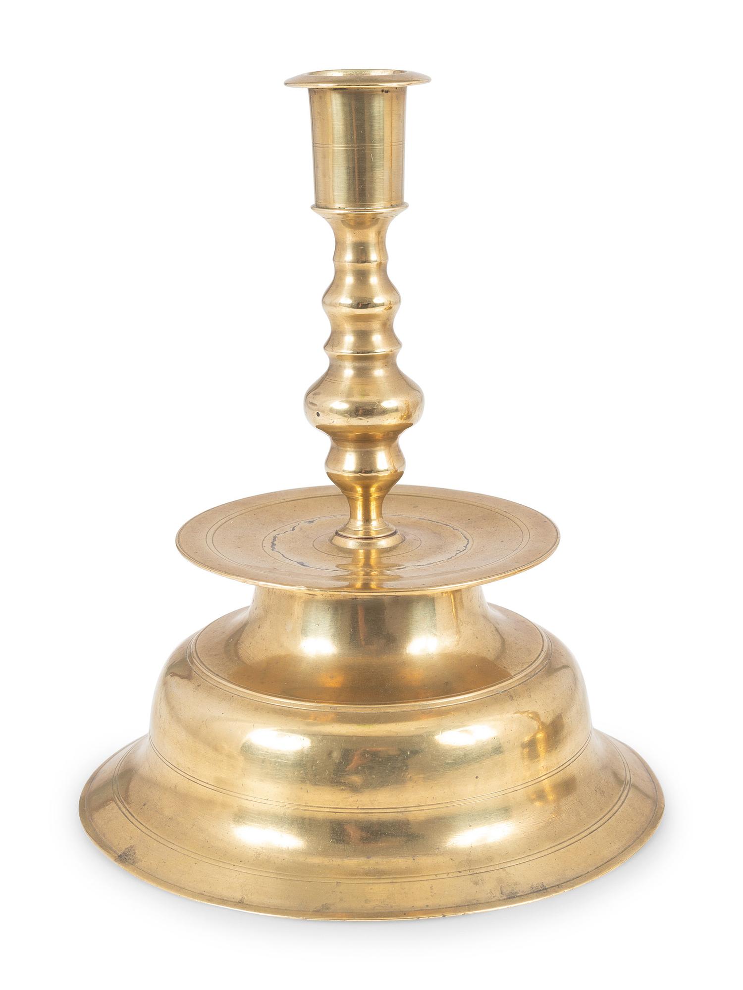 A Continental Brass Bell-Bottom Candlestick