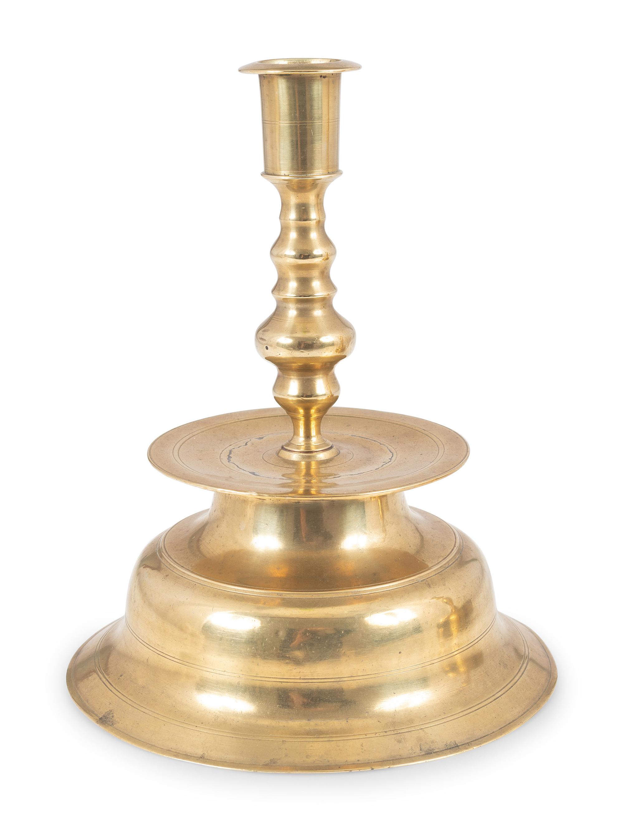 A Continental Brass Bell-Bottom Candlestick