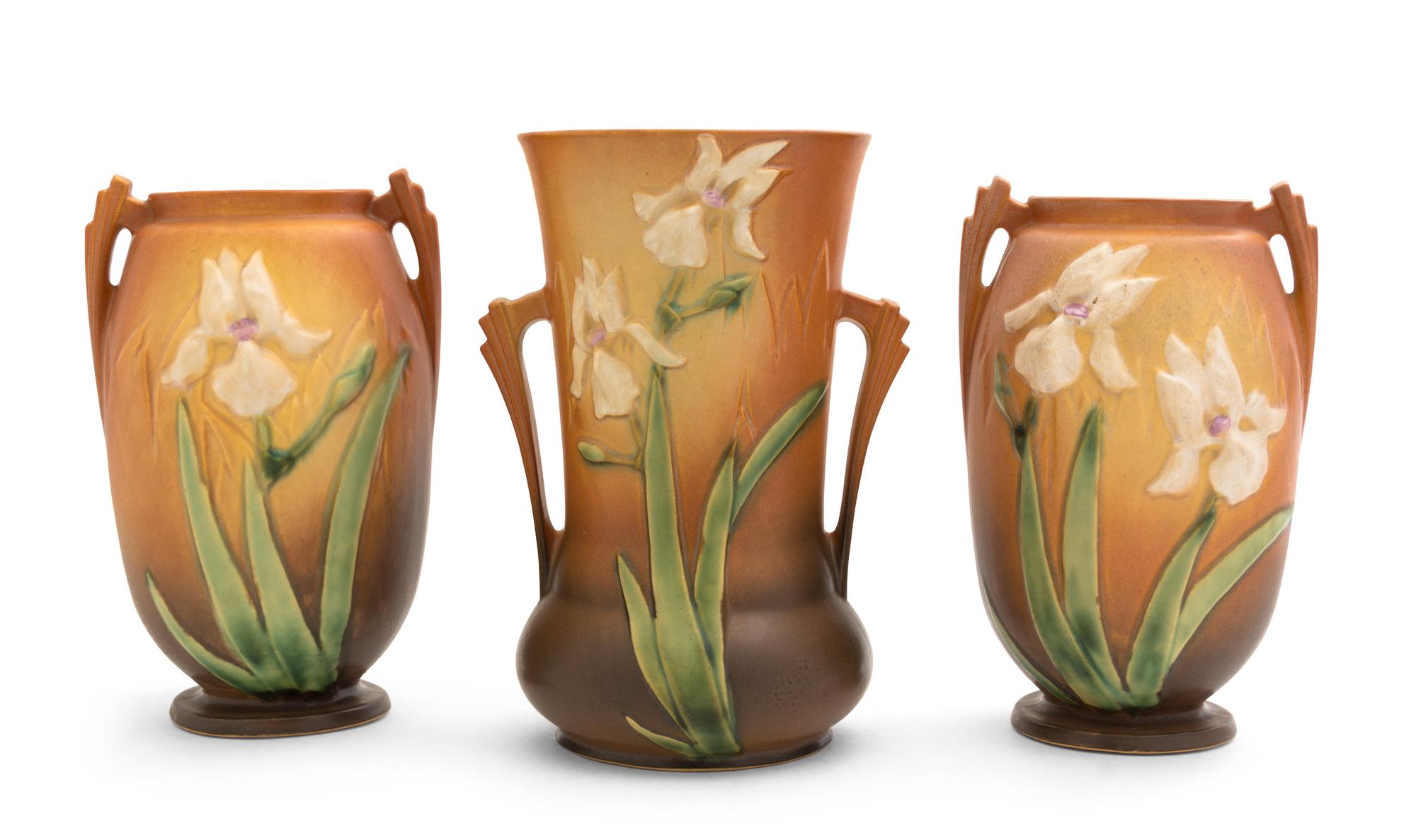 Three Roseville Iris Pottery Vases Height of first 10 1/4 inches, pair 9 1/2 inches.