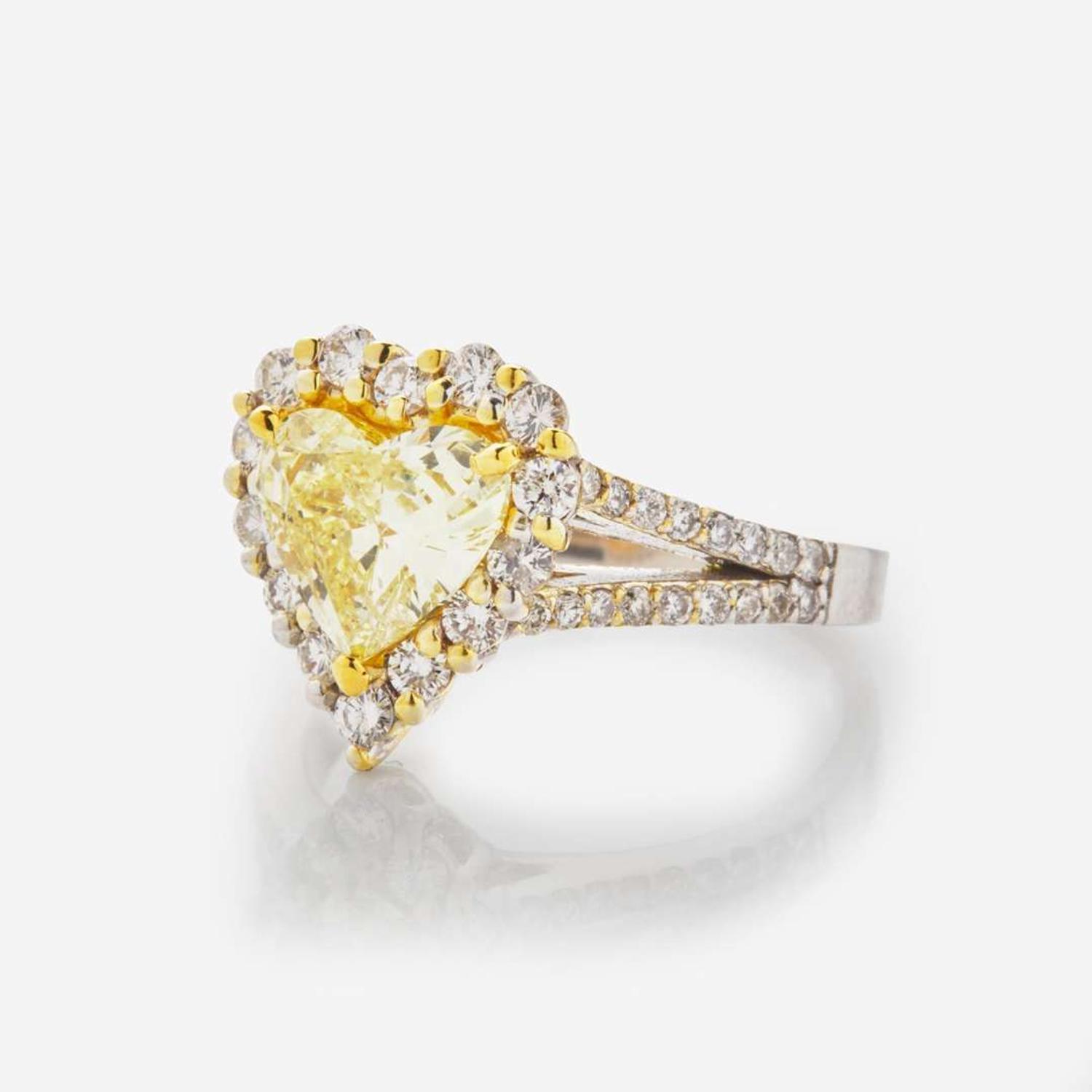 A Heart-Shape Colored Diamond, Diamond, and 18K Gold Ring 1.68 Carat Natural Fancy Yellow Heart-Shaped Diamond, GIA Certified