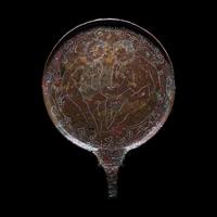 An Etruscan Bronze Mirror with Incised Scene of Hercules and Apollo