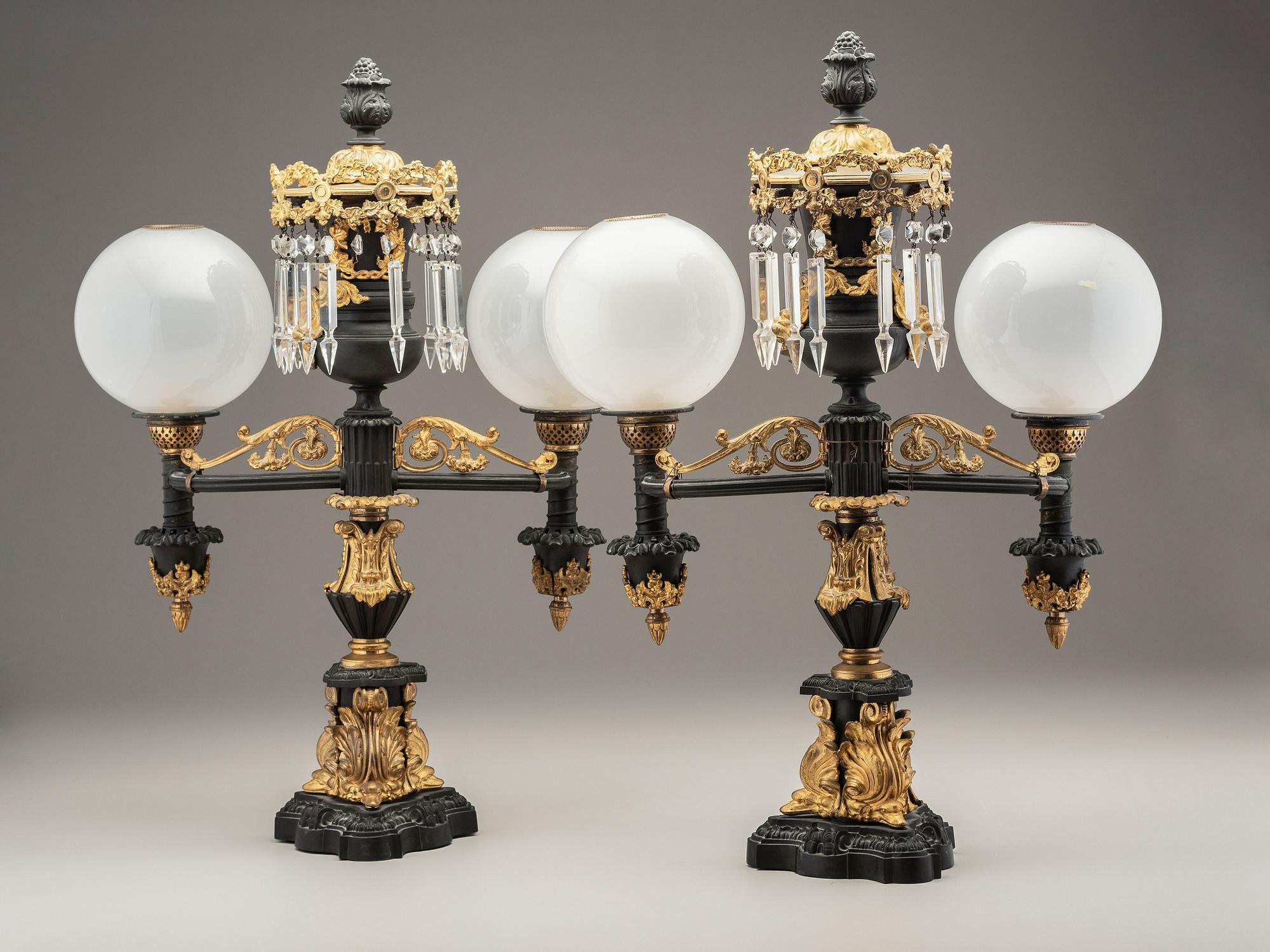 A Pair of Classical Gilt and Patinated Bronze Two-Light Argand Lamps with Shades