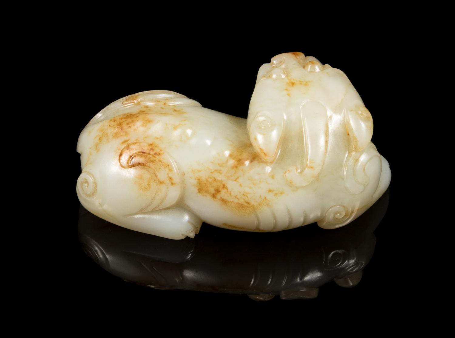 A Pale Celadon and Russet Jade Figure of a Mythical Beast Length 3 1/4 inches. — 19TH CENTURY