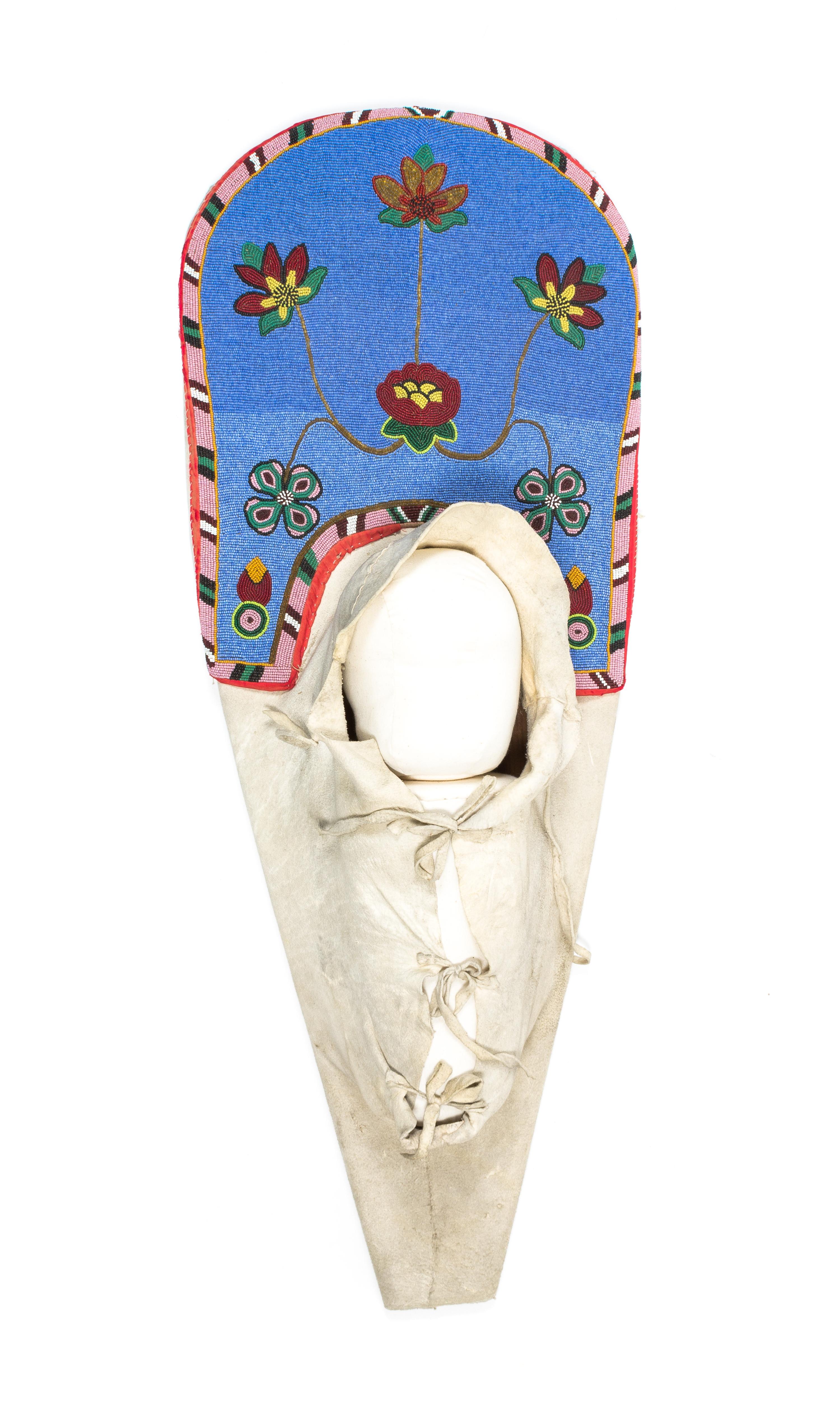 A Plateau Beaded Cradle Length 34 1/2 inches.