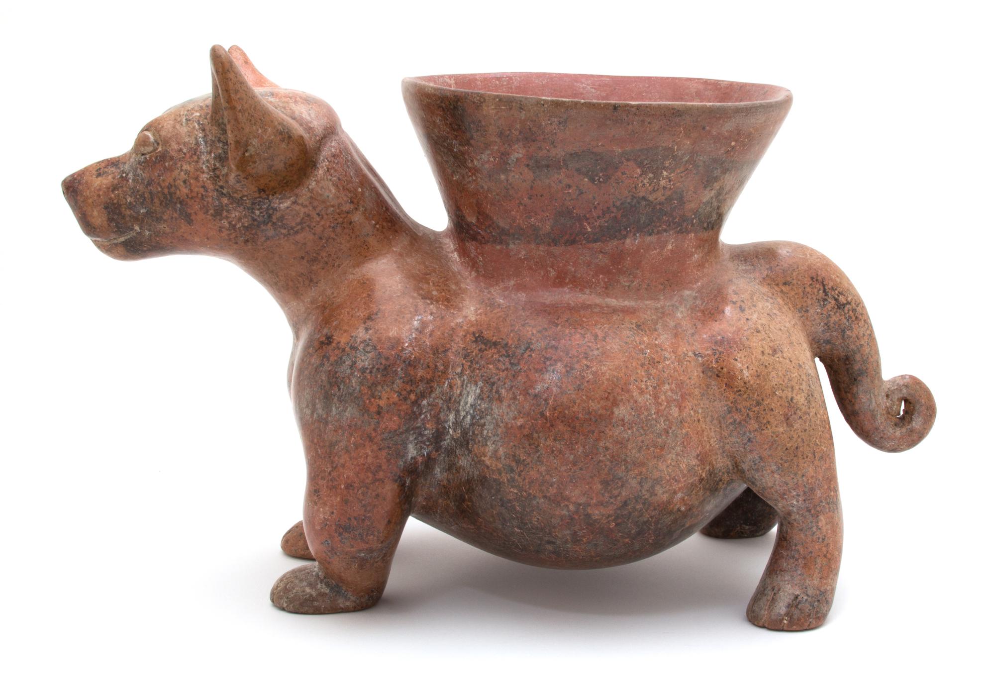 A Pre-Columbian Style Colima Dog-Form Vessel Height 11 x width 9 x depth 18 inches.