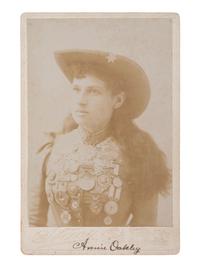[OAKLEY, Annie (1860-1926)]. Cabinet card portrait of Annie Oakley wearing her shooting medals. New York: Stacy, ca 1890s.