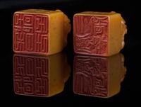 A Pair of Soapstone Seals Height of pair 1 5/8 inches.