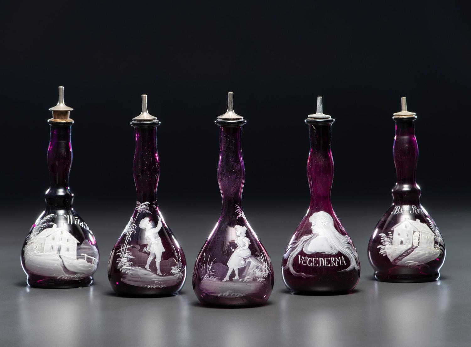 Five 'Mary Gregory' Amethyst Glass Barber Bottles