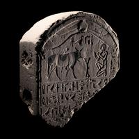 An Egyptian Limestone Round-Topped Stele