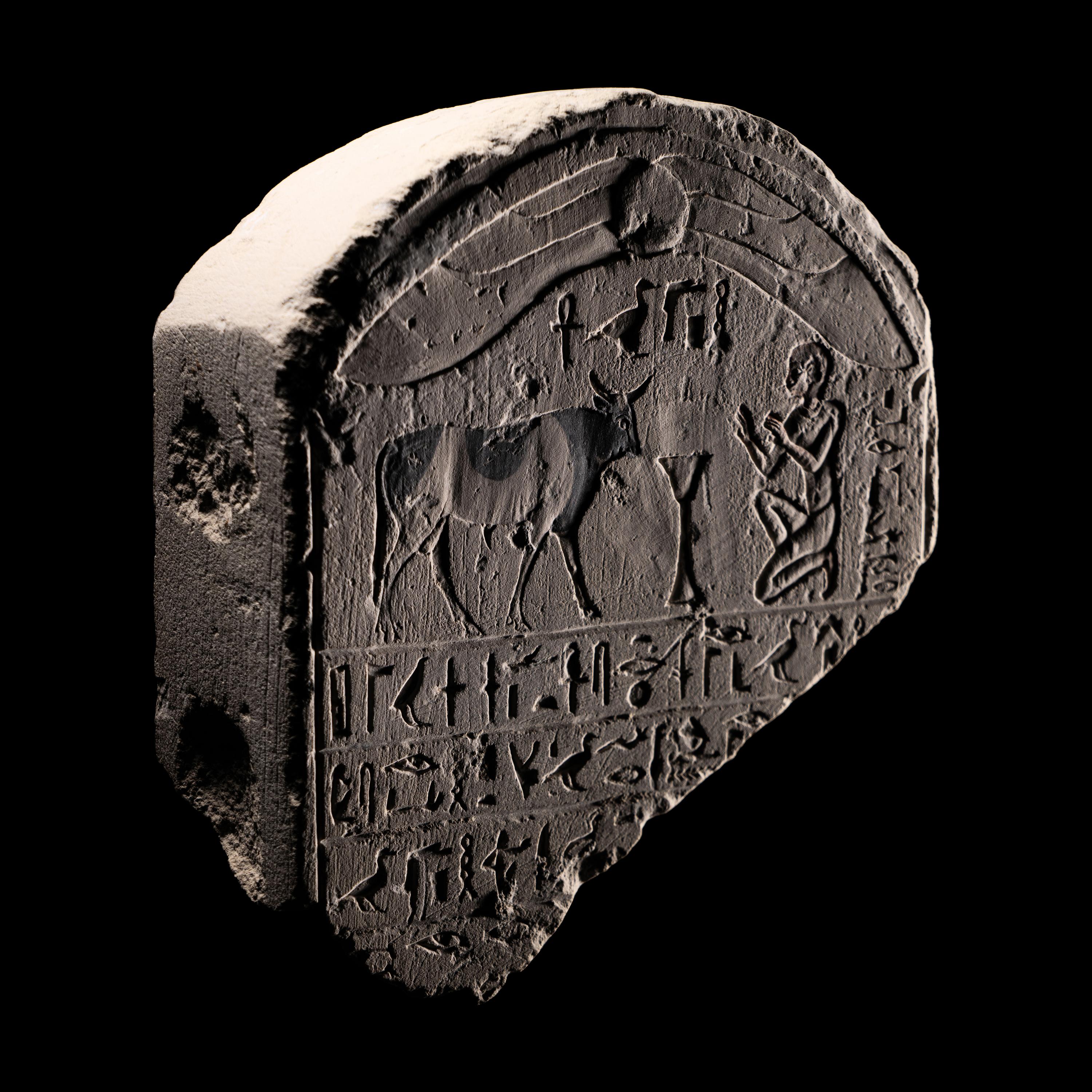 An Egyptian Limestone Round-Topped Stele