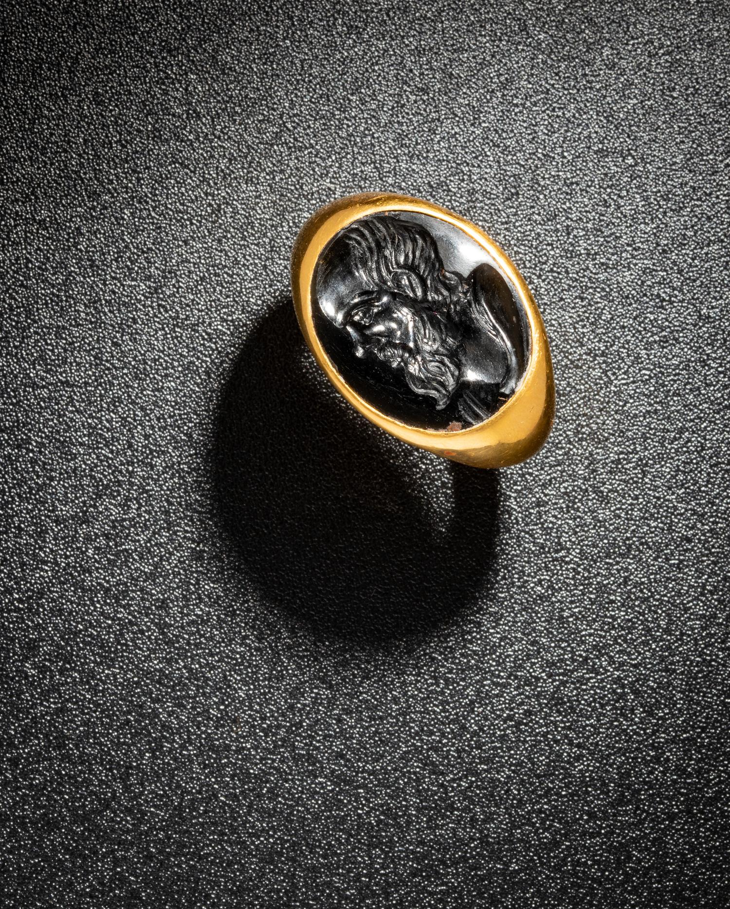 A Roman Black Jasper Intaglio with a Portrait Head of Socrates — Set in a gold ring