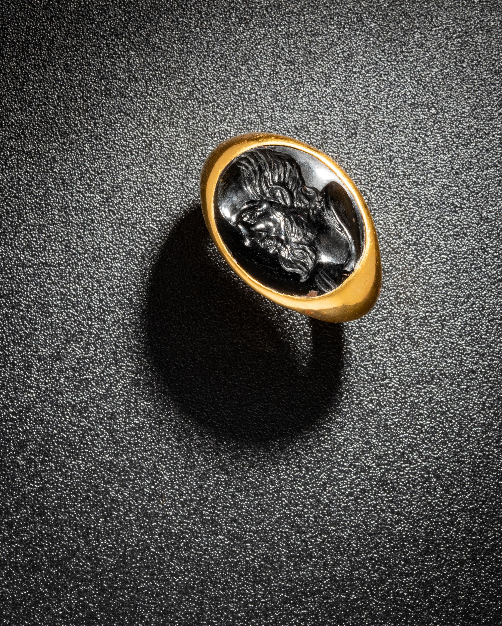 A Roman Black Jasper Intaglio with a Portrait Head of Socrates — Set in a gold ring