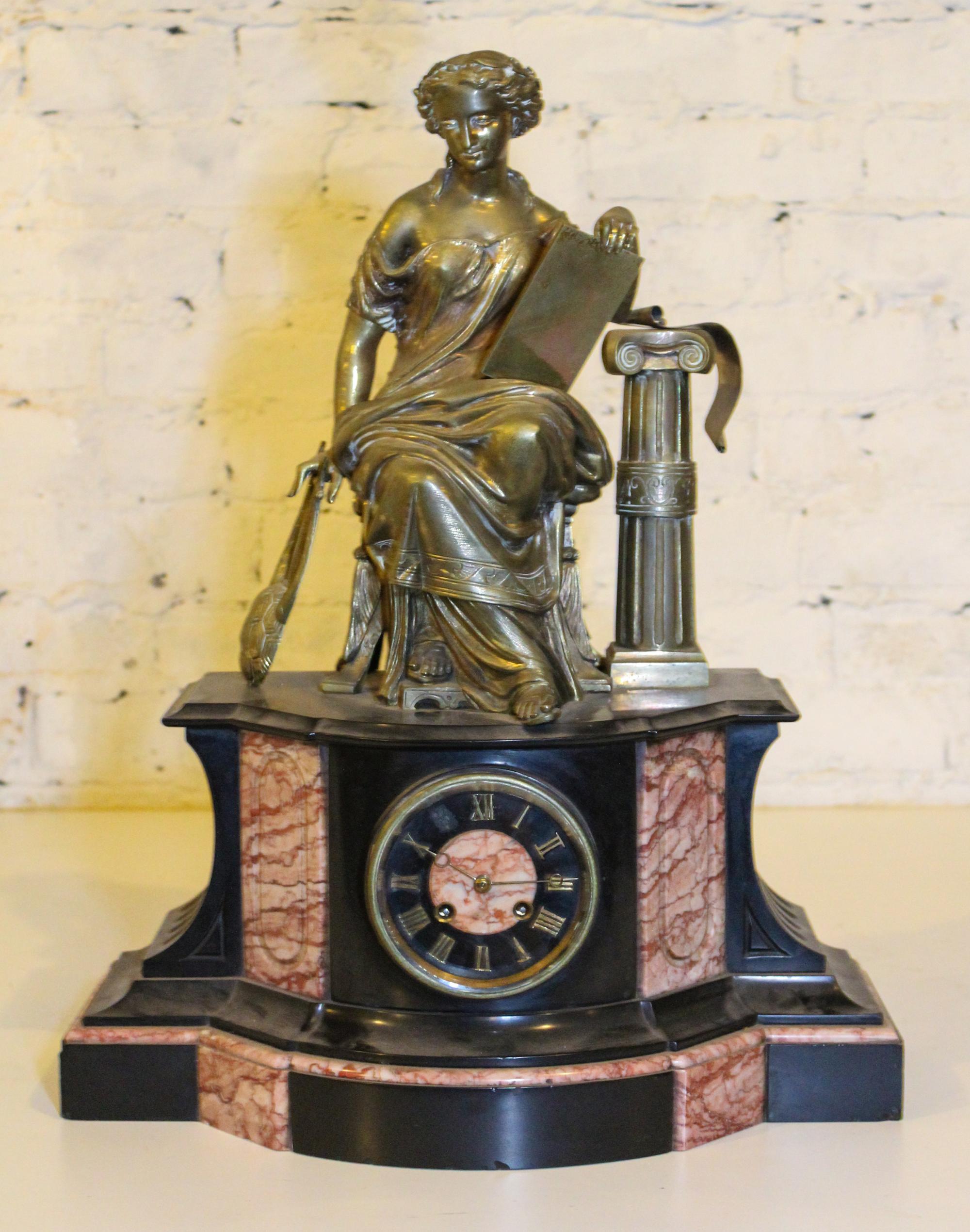 A Victorian Figural Mantel Clock. Height 22 inches.
