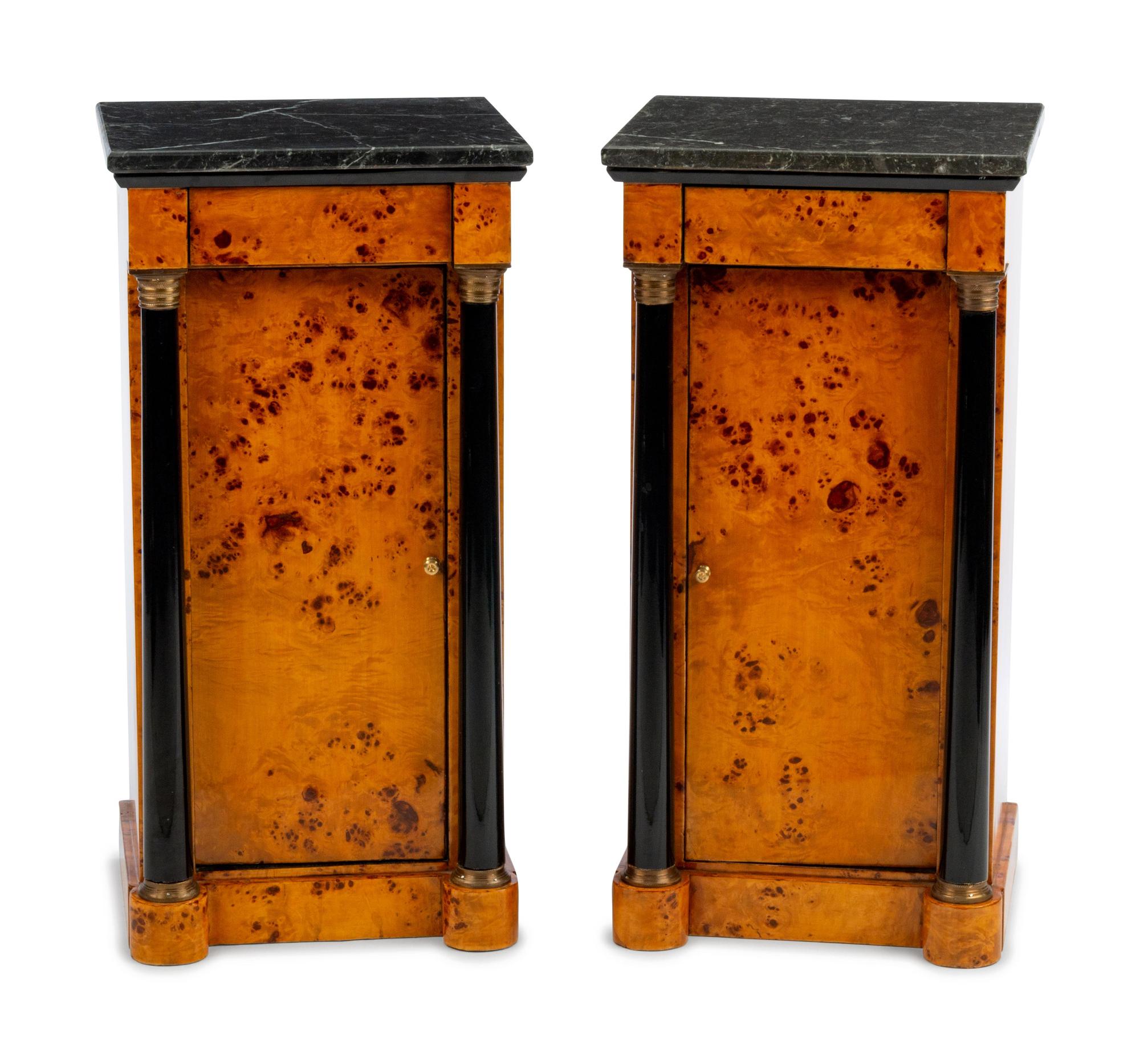 A Pair of Empire Style Parcel Ebonized Marble-Top Cabinets