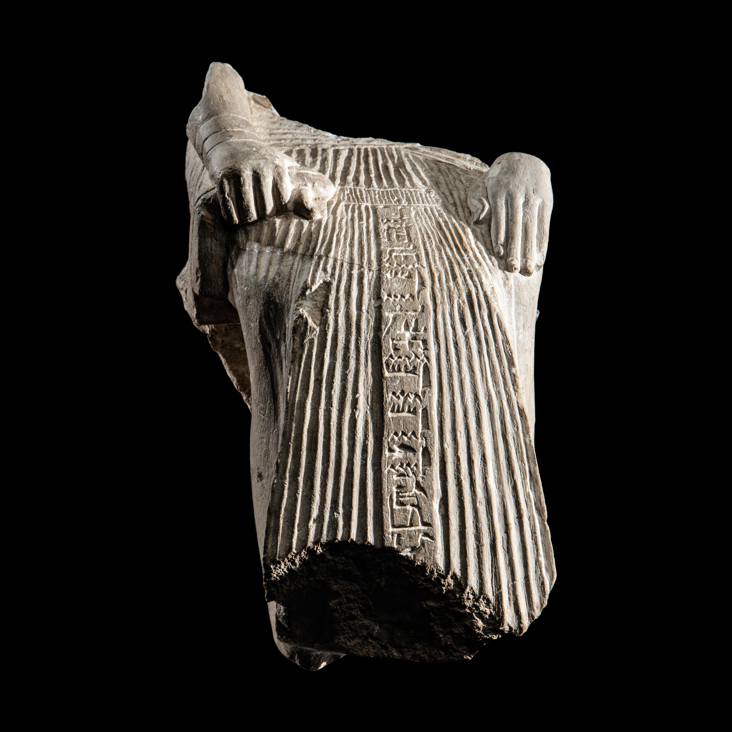 An Egyptian Limestone Fragment of a Seated Scribe