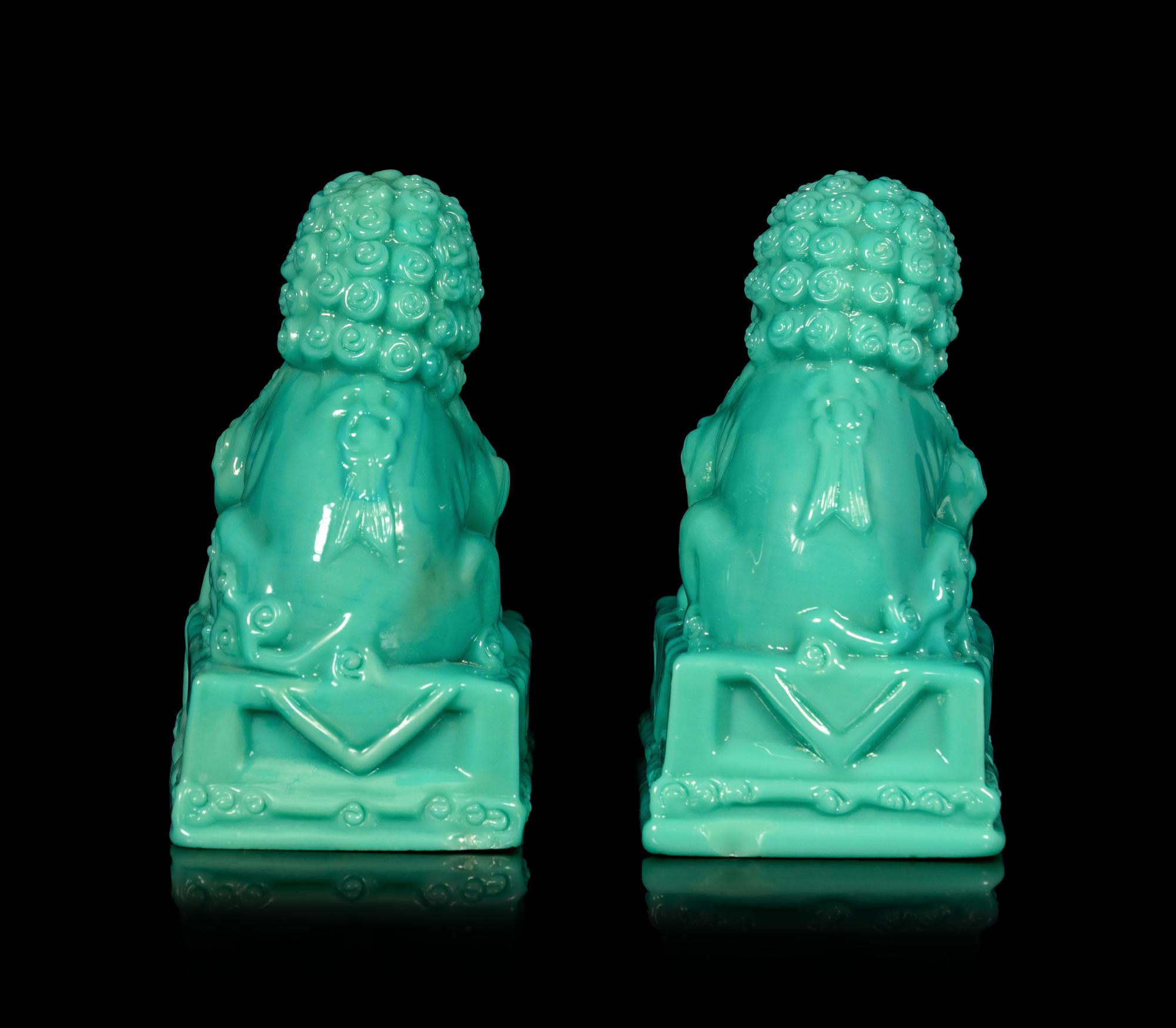 A Pair of Chinese Molded Glass Figures of Fu Lions