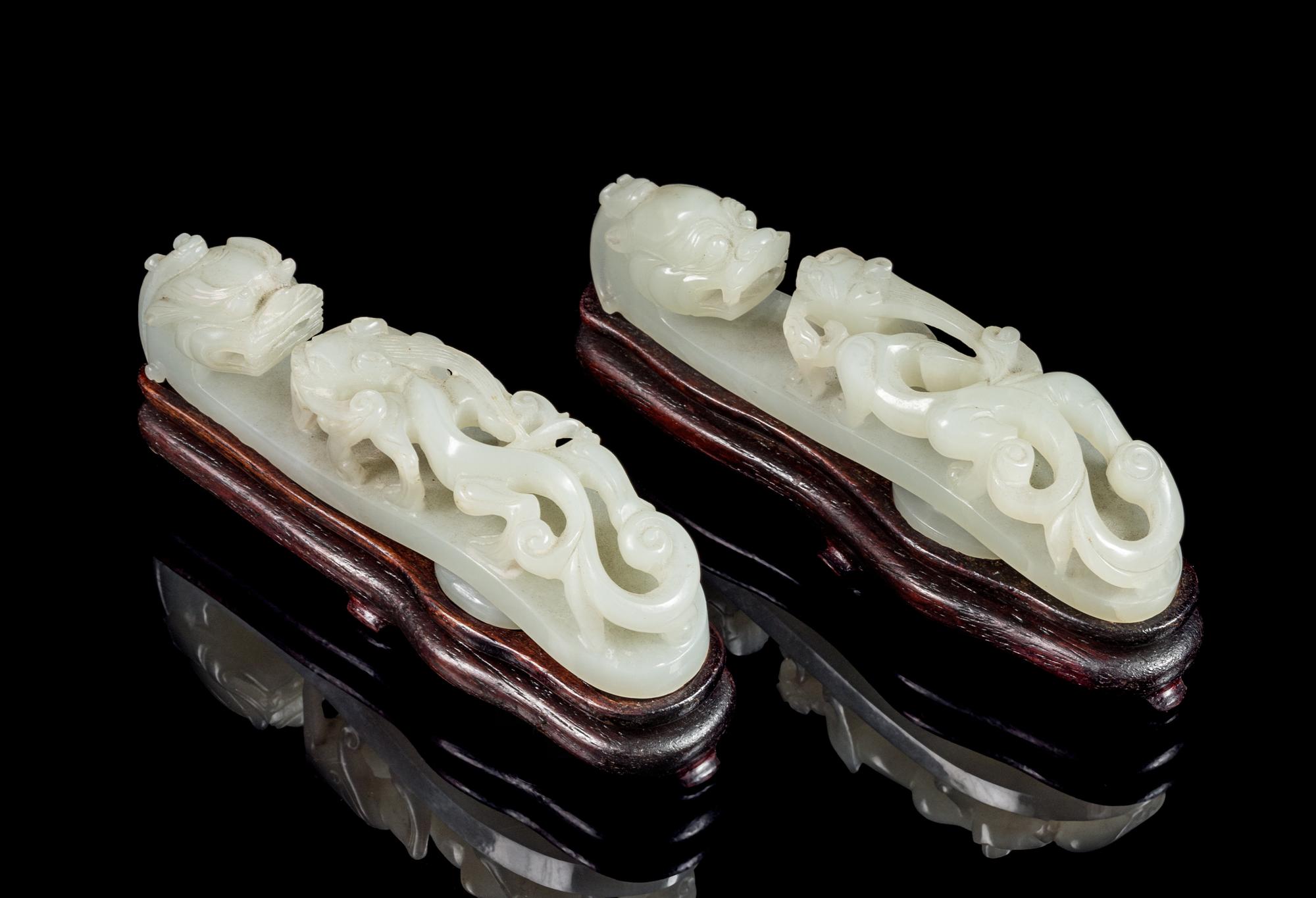 A Pair of Pale-Celadon Jade 'Dragon' Belt Hooks Length of each 4 3/8 inches. — 18TH/19TH CENTURY