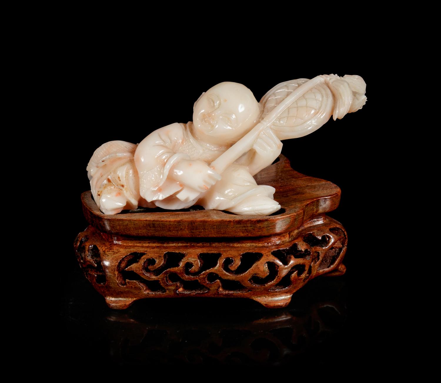 A Pink Coral Carving of a Boy