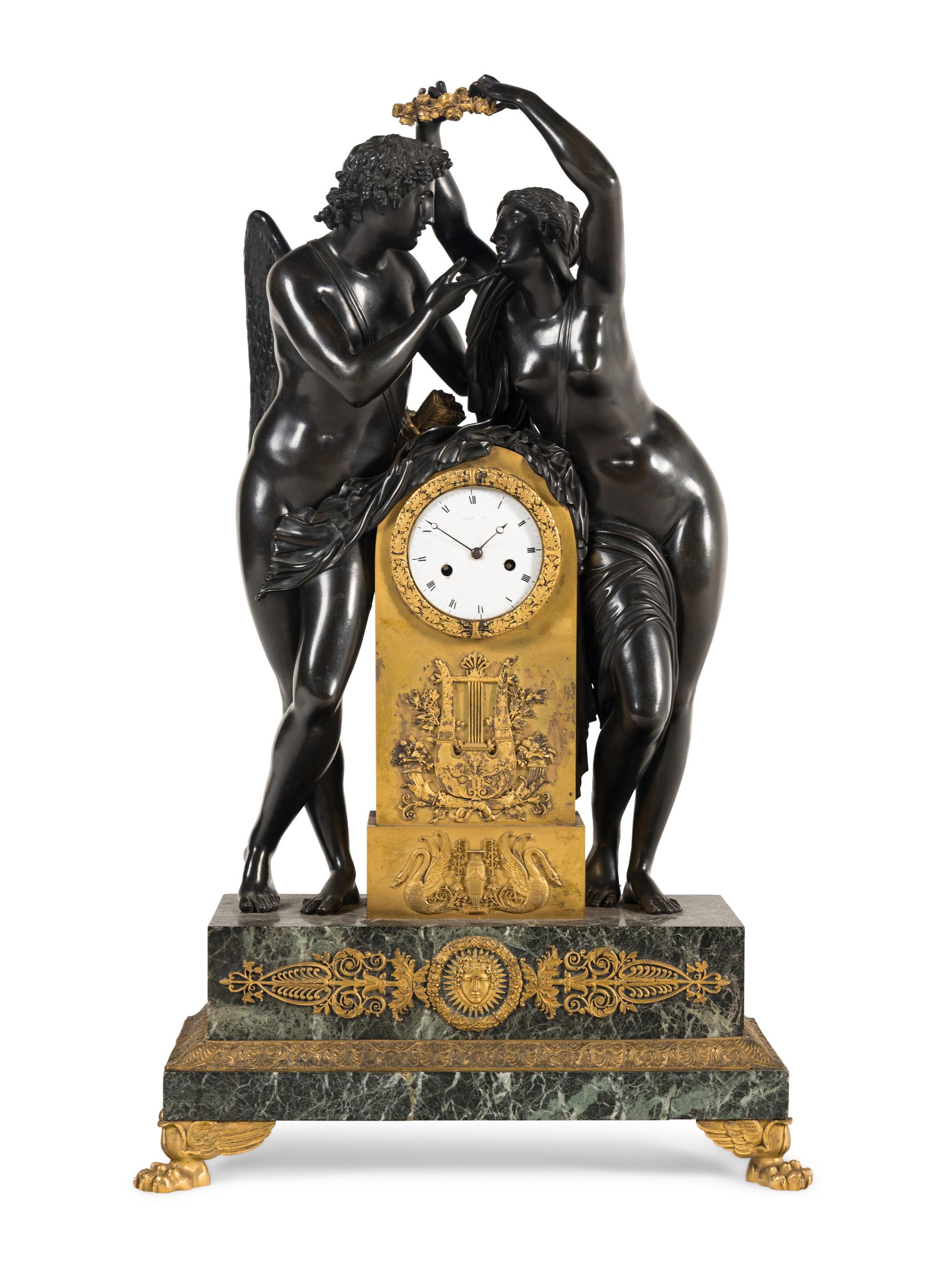 A French Parcel Gilt and Patinated Bronze Figural Mantel Clock