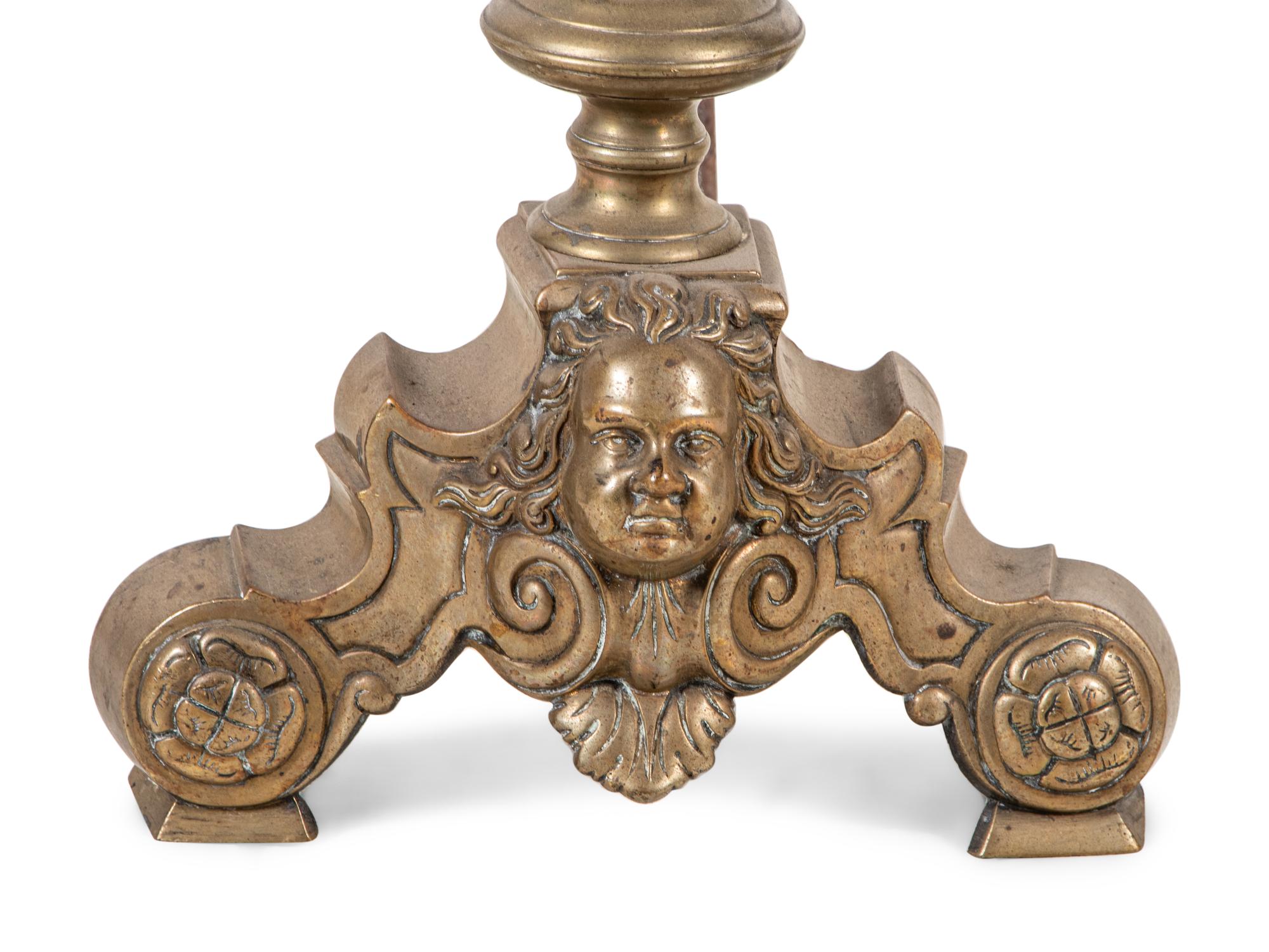 A Pair of Continental Brass Andirons with Masks