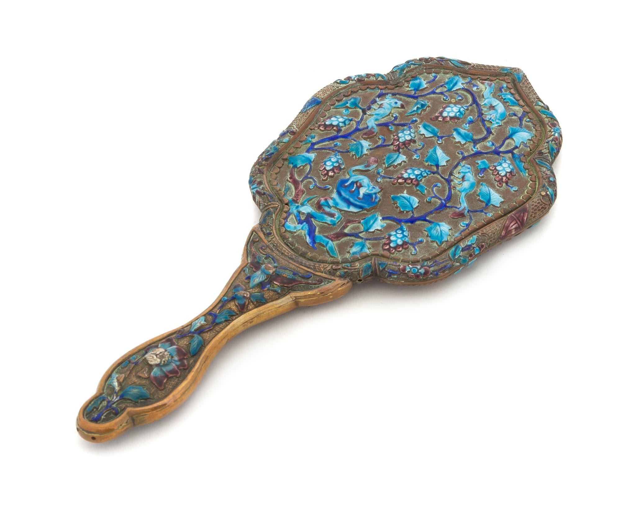 An Enamel on Copper Hand Mirror Length 11 1/8 inches.