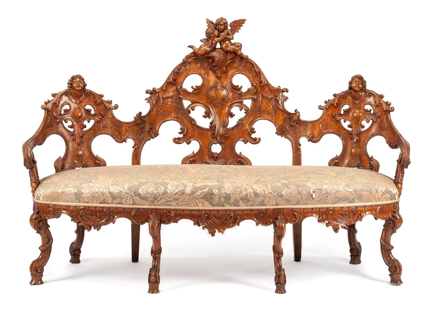 A Black Forest Carved Walnut Settee Height 47 1/2 x width 71 x depth 26 inches. — 19TH CENTURY